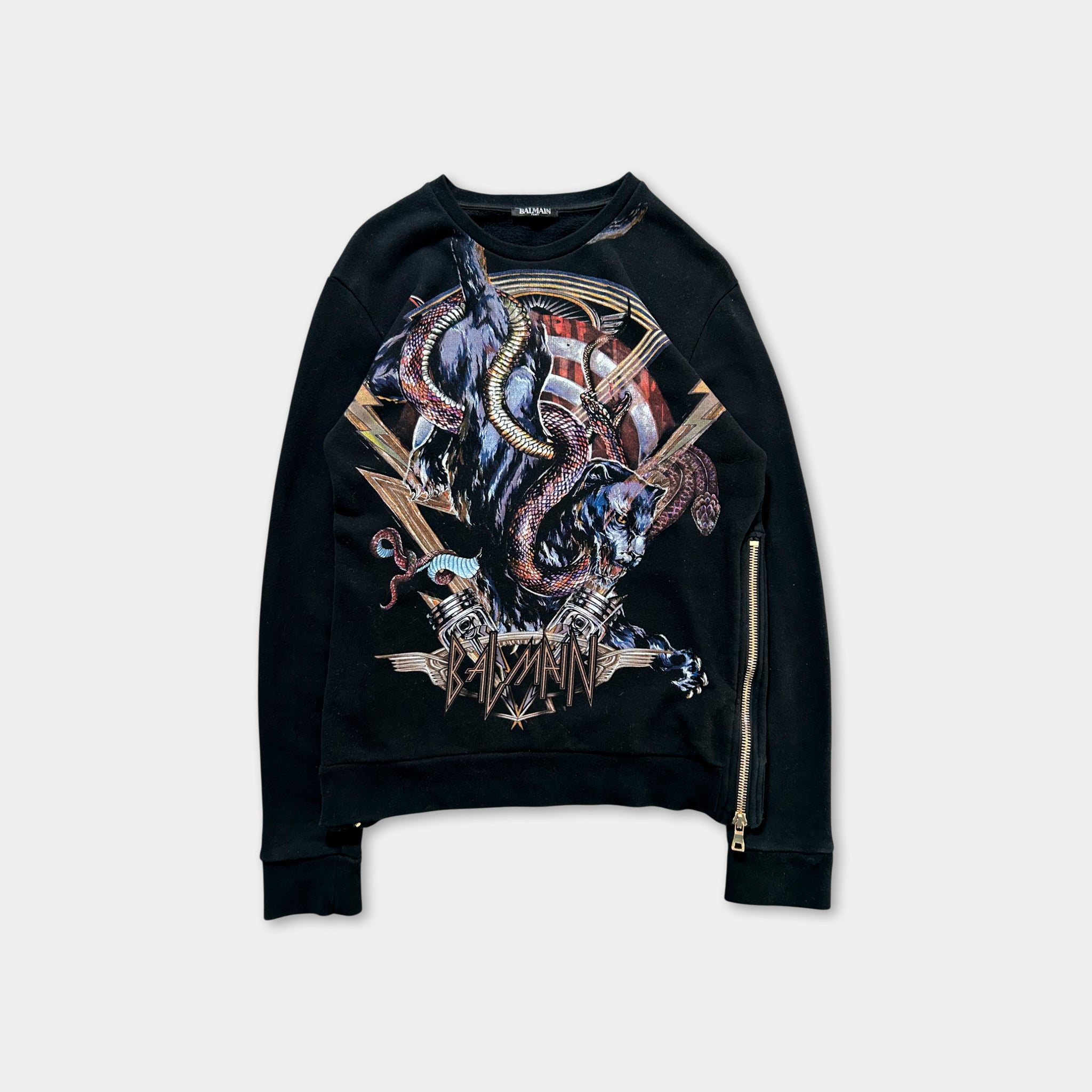 A black sweatshirt with a graphic design featuring a large, abstract creature with multiple arms and a snake-like appearance.