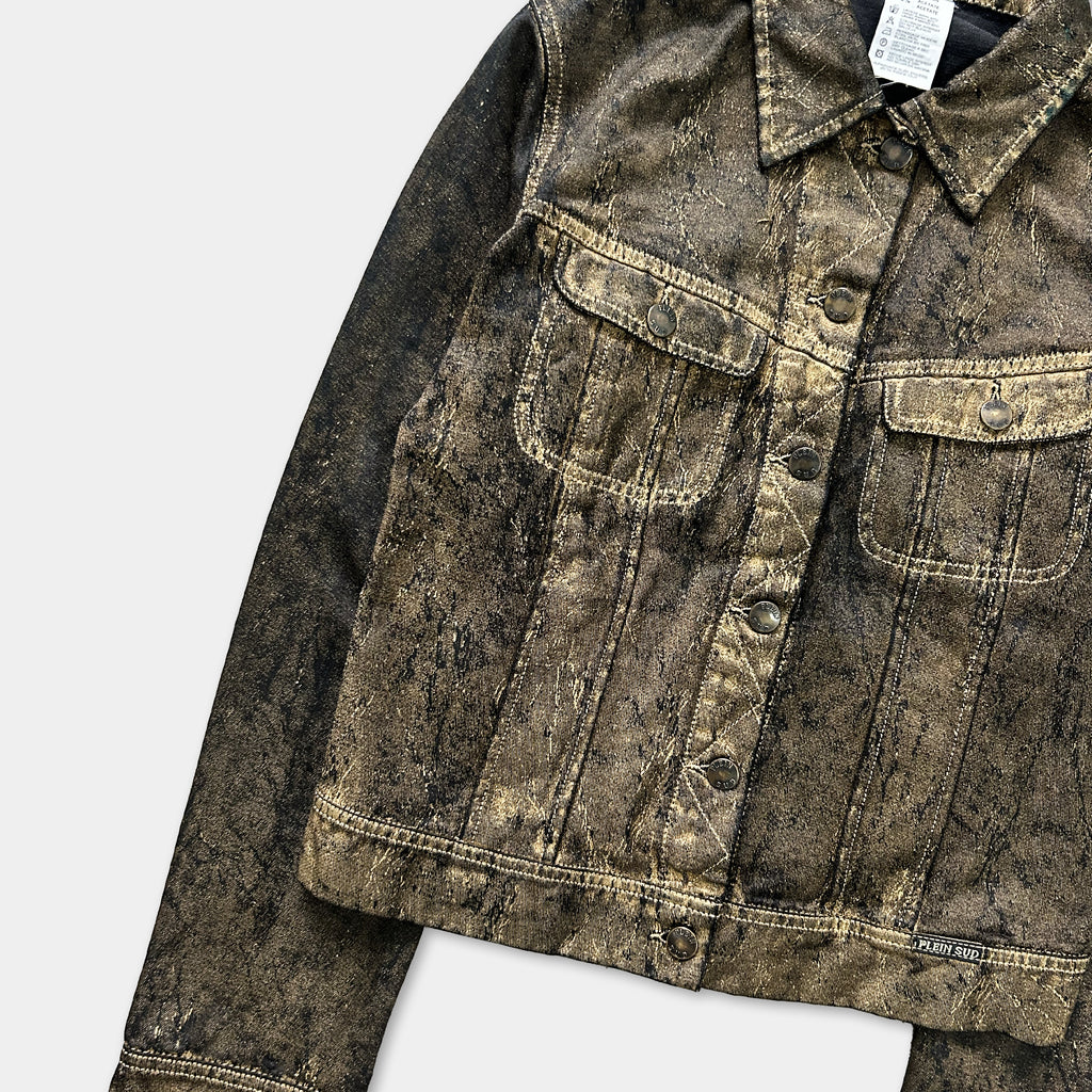 A close-up view of a dark denim jacket with a distressed, worn appearance.