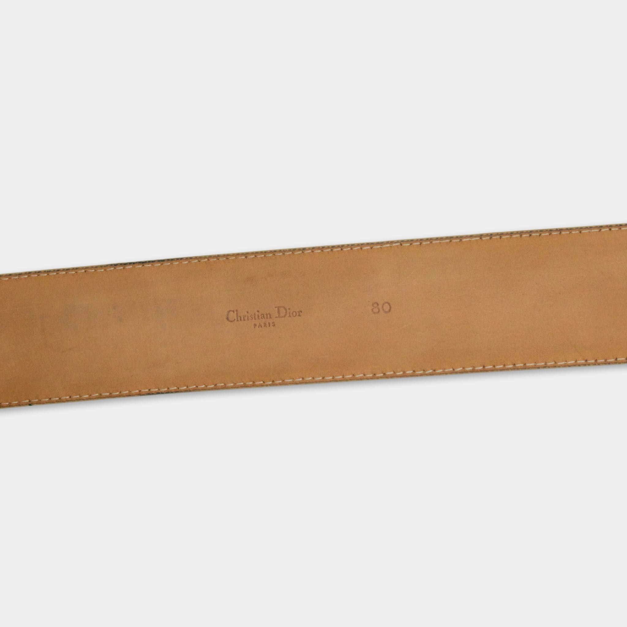 A tan leather belt with the brand name "Christian Dior" printed on it.