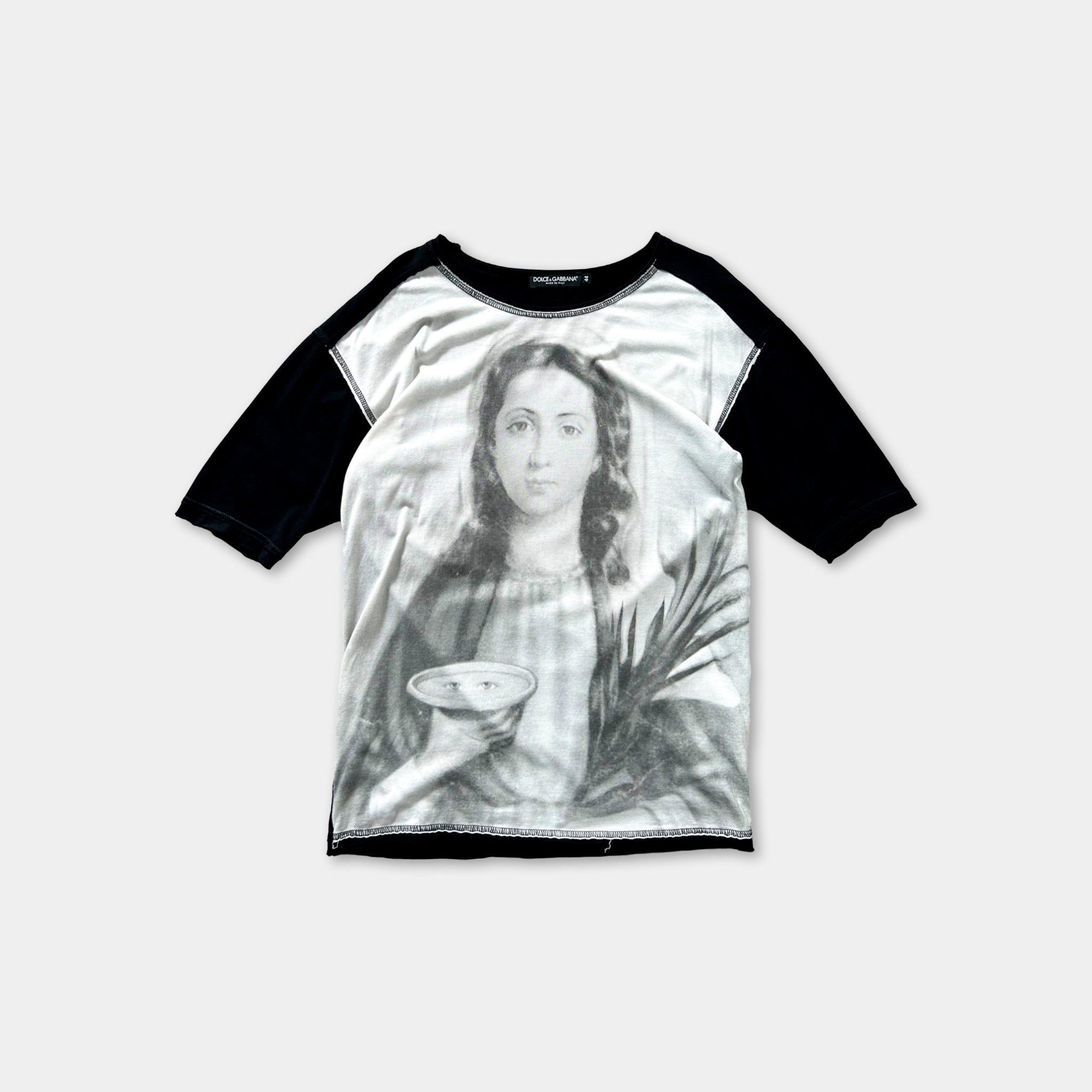 The image is a black and white t-shirt with a printed image of a woman holding a bowl.