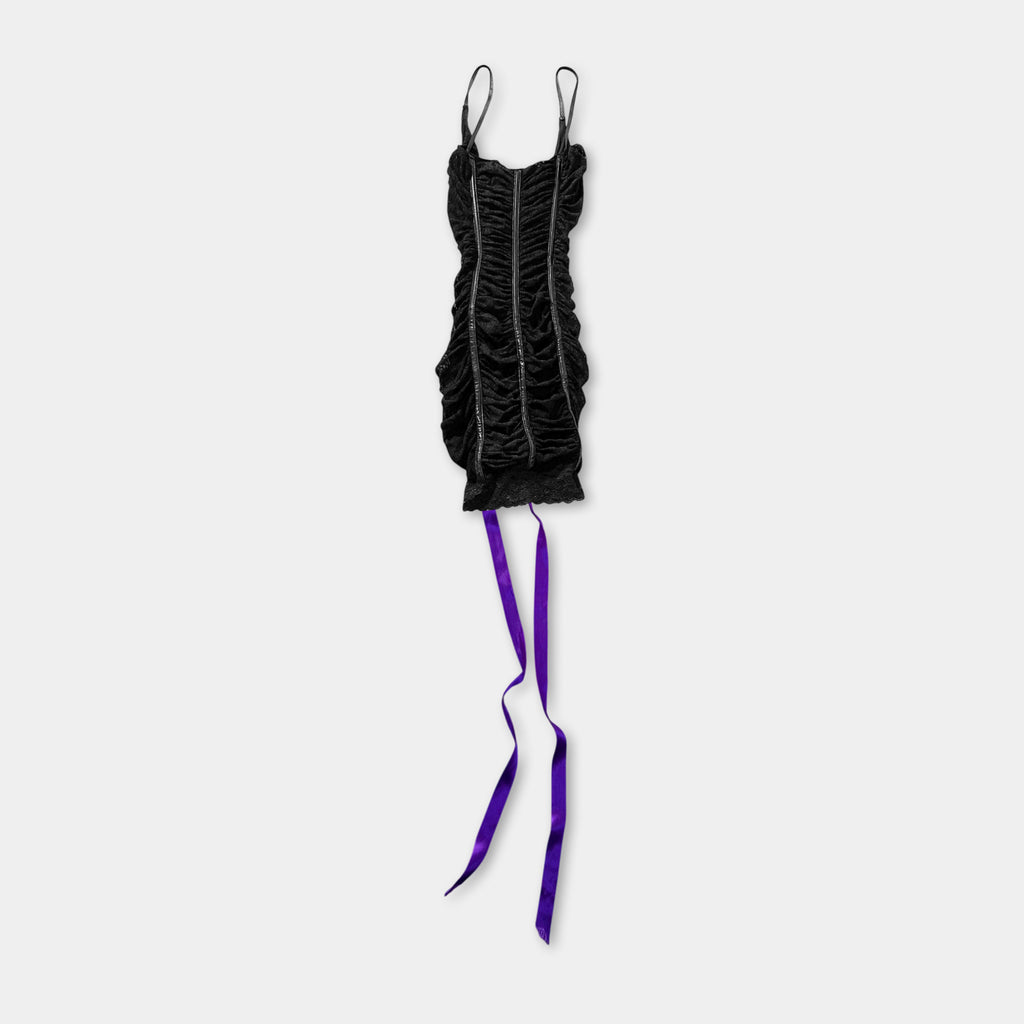 A black dress with ruched bodice and purple ribbons hanging from the bottom.