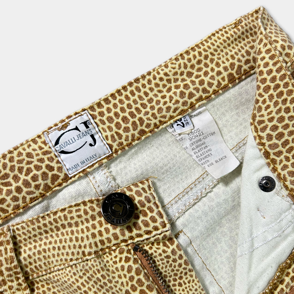 a pair of leopard print jeans with a label attached to the waistband.