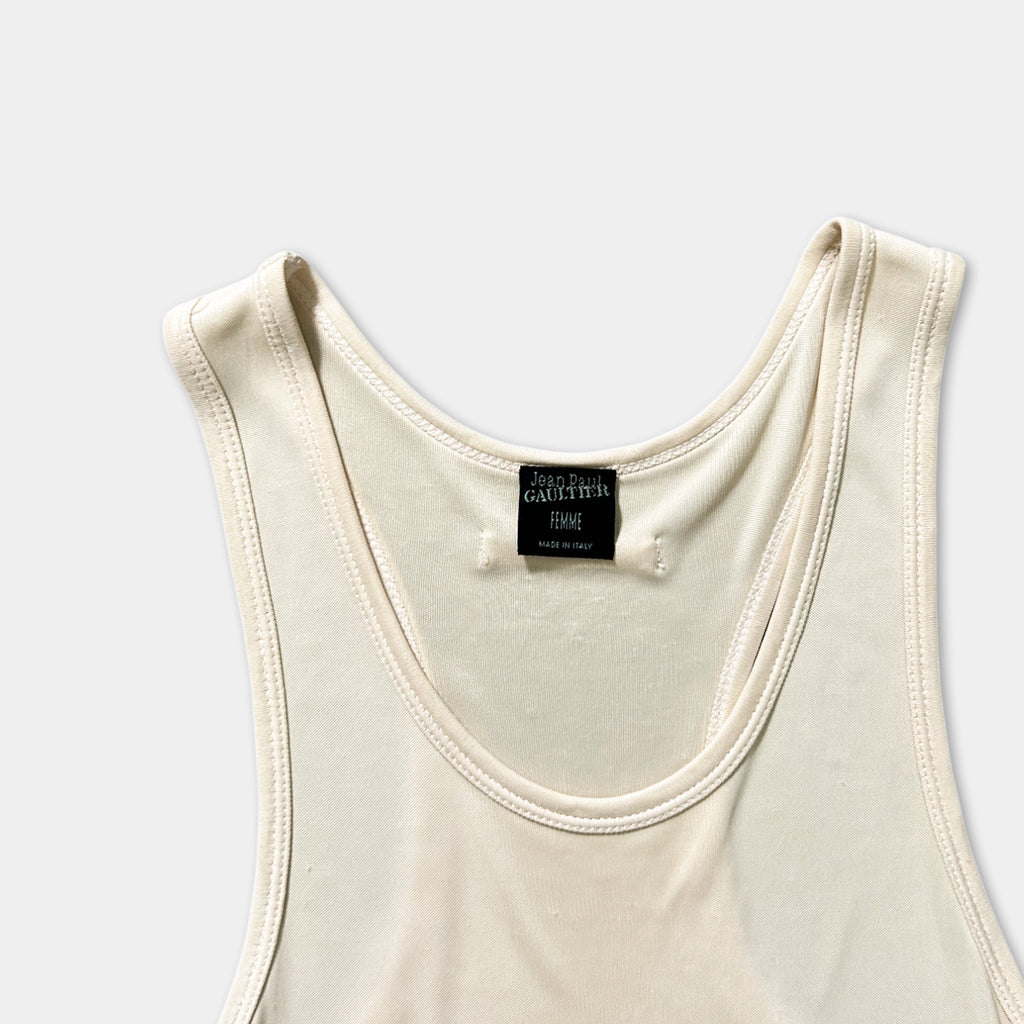 A white tank top with a label on the neckline.