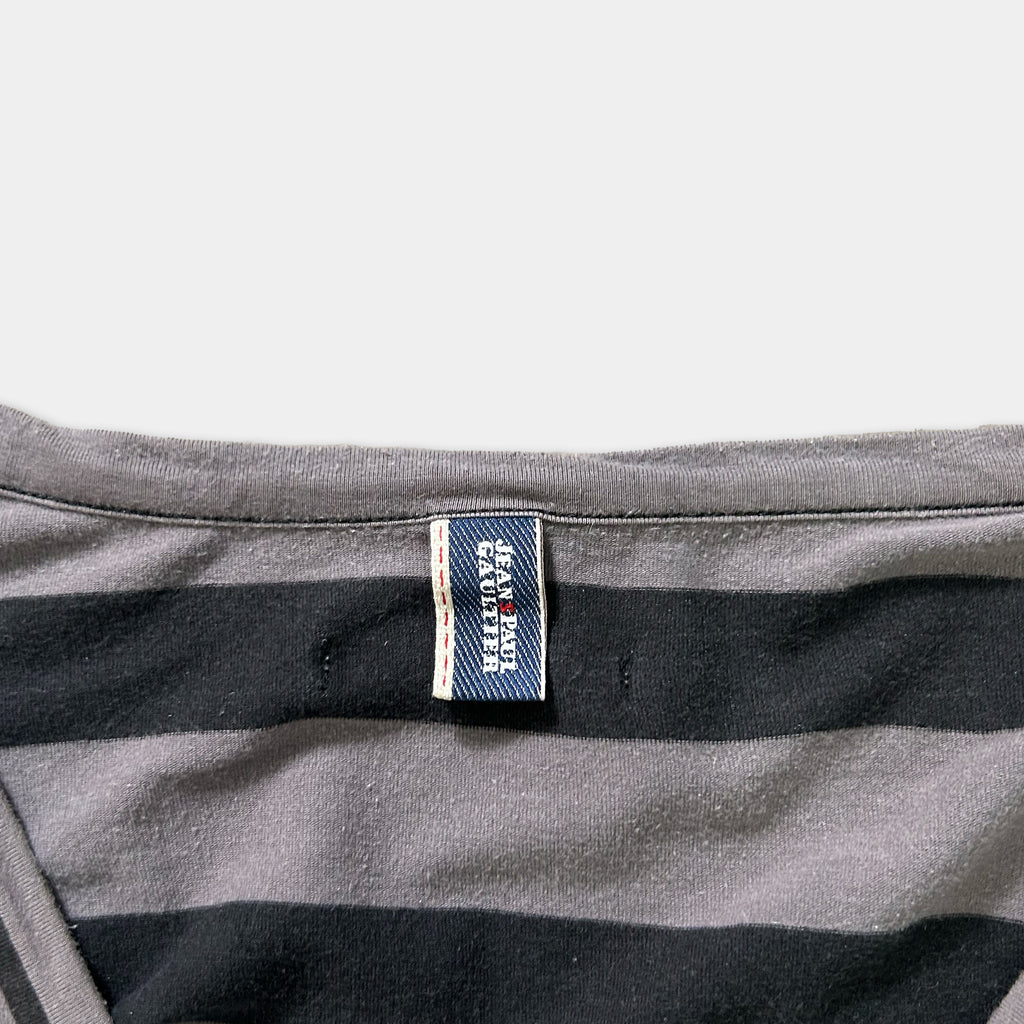 A gray and black striped shirt with a small blue label attached to the collar.