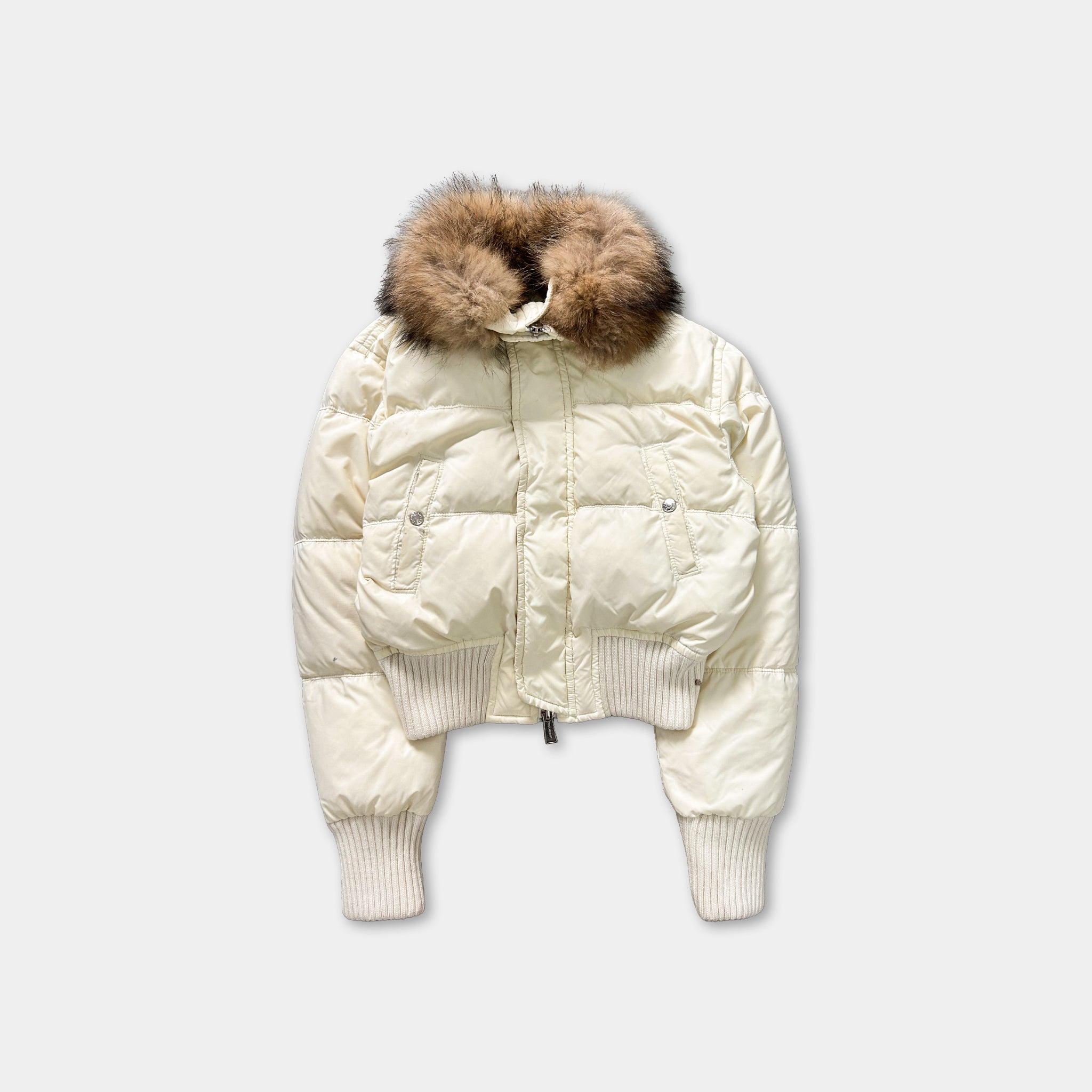 A white puffy jacket with a fur collar is shown against a plain background.