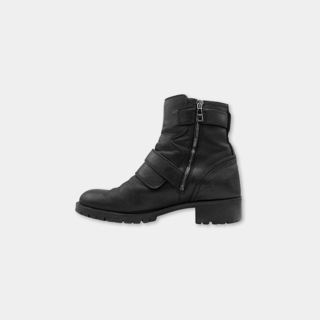 A black leather boot with a zipper closure and a chunky sole.