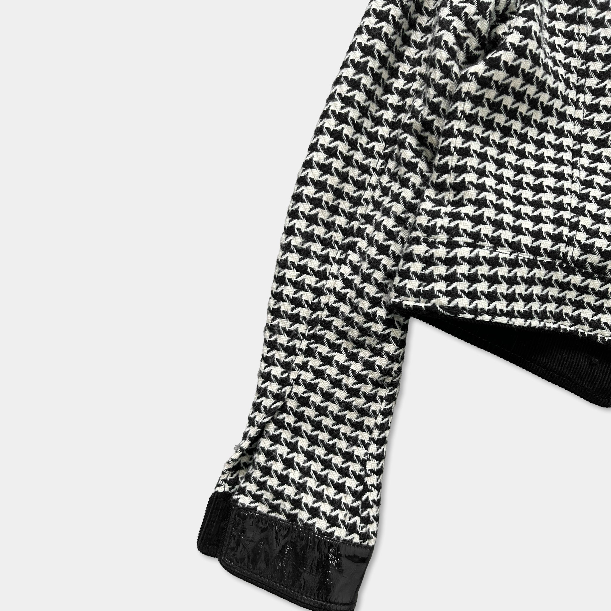 A black and white patterned jacket with a distinctive houndstooth design.