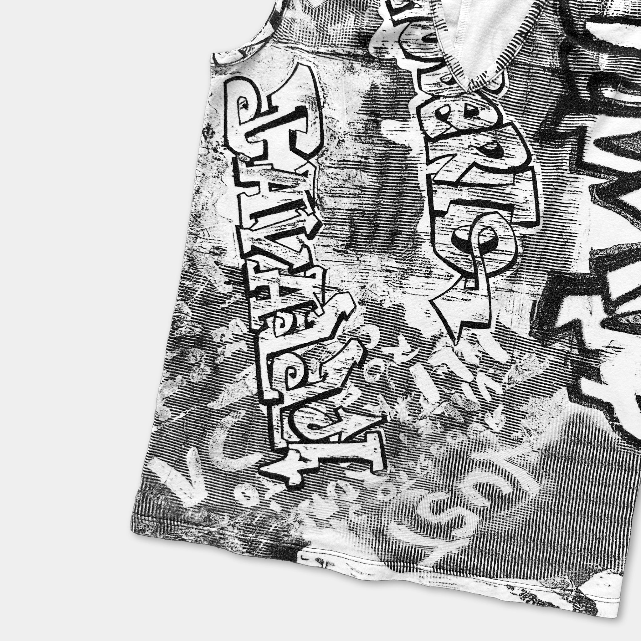 a close-up view of a black and white graphic design on a fabric, with various stylized text and patterns.