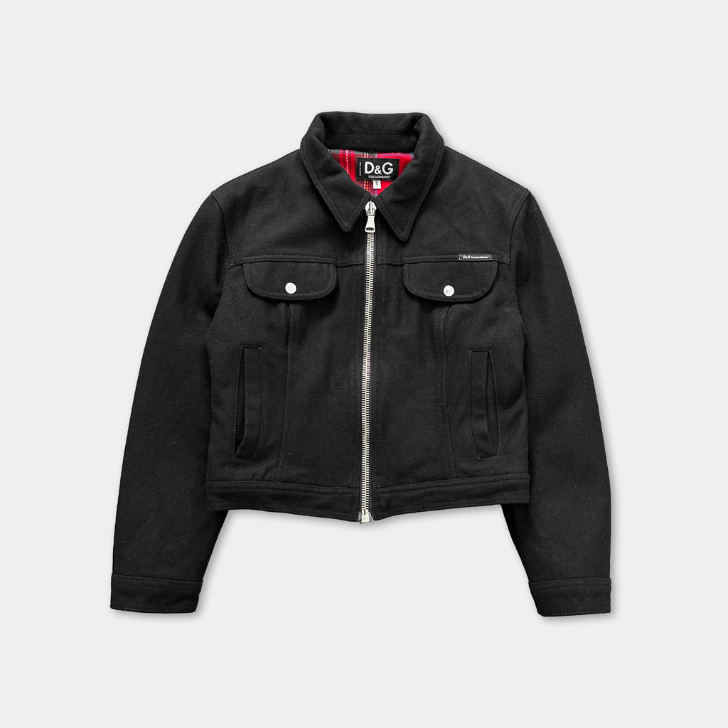 A black jacket with a zipper and two pockets, featuring the logo of the fashion brand Dolce & Gabbana.