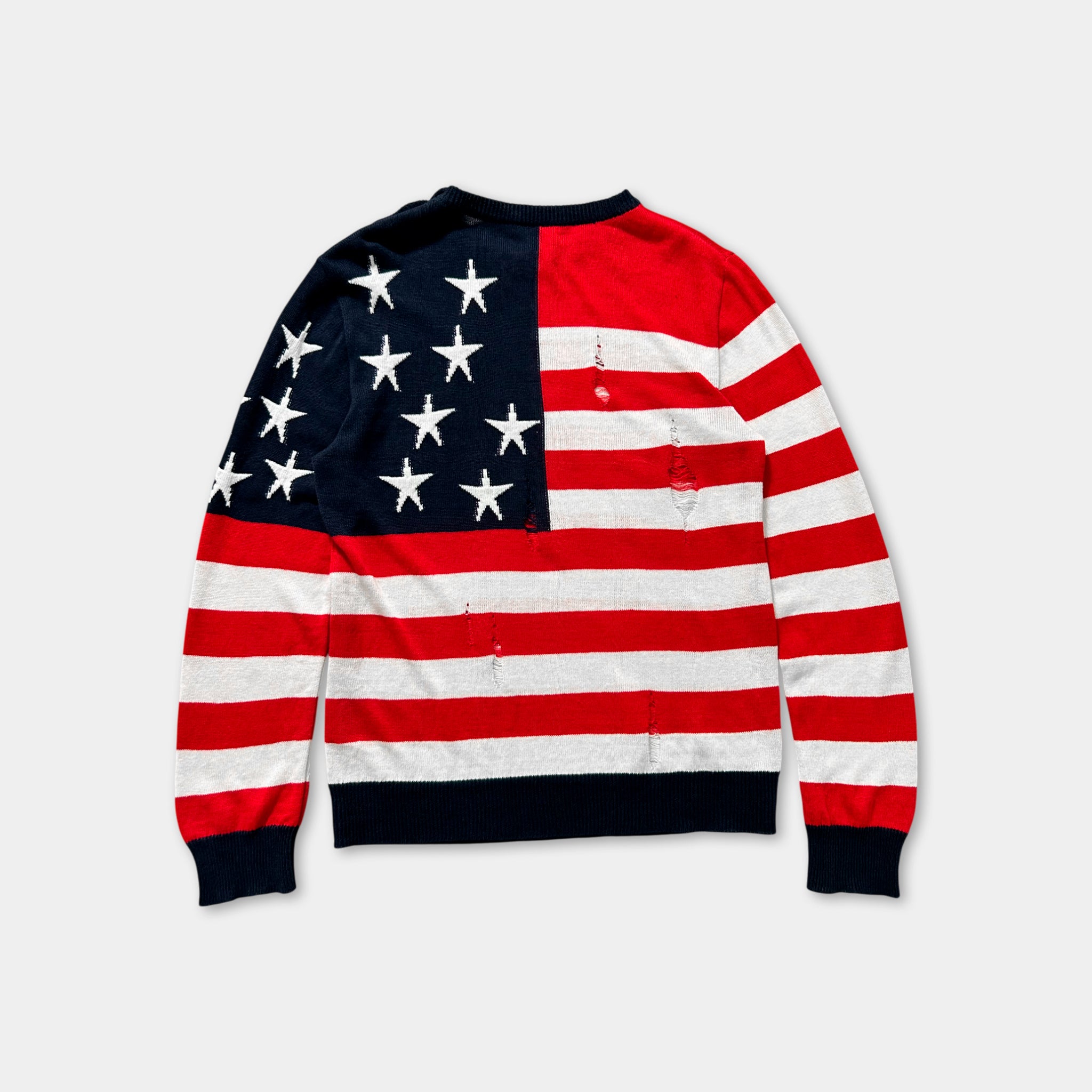 A red, white, and blue sweater with a large American flag design on the back.