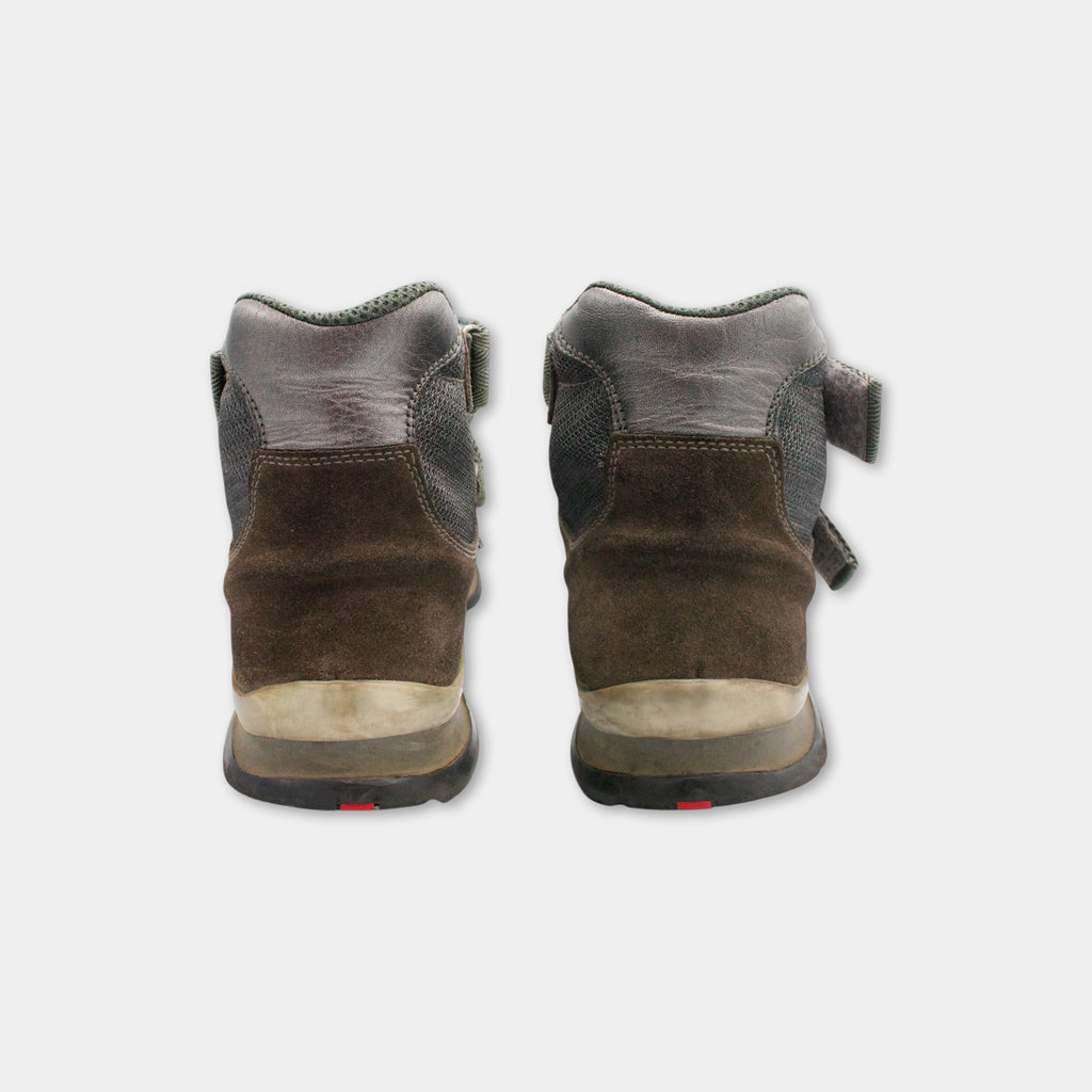 A pair of brown hiking boots with a gray sole, designed for outdoor activities.