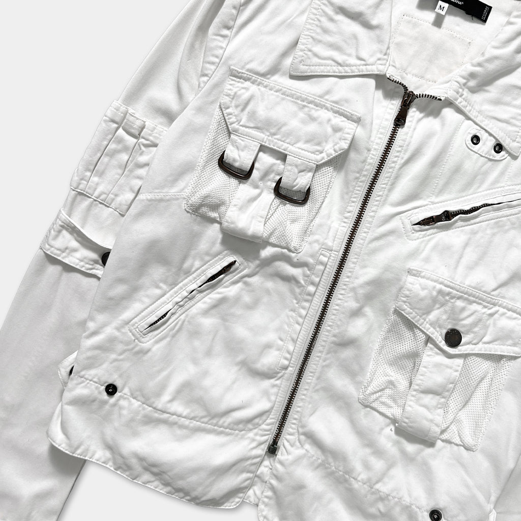 A white jacket with multiple pockets and zippers, including a zipper running down the center.