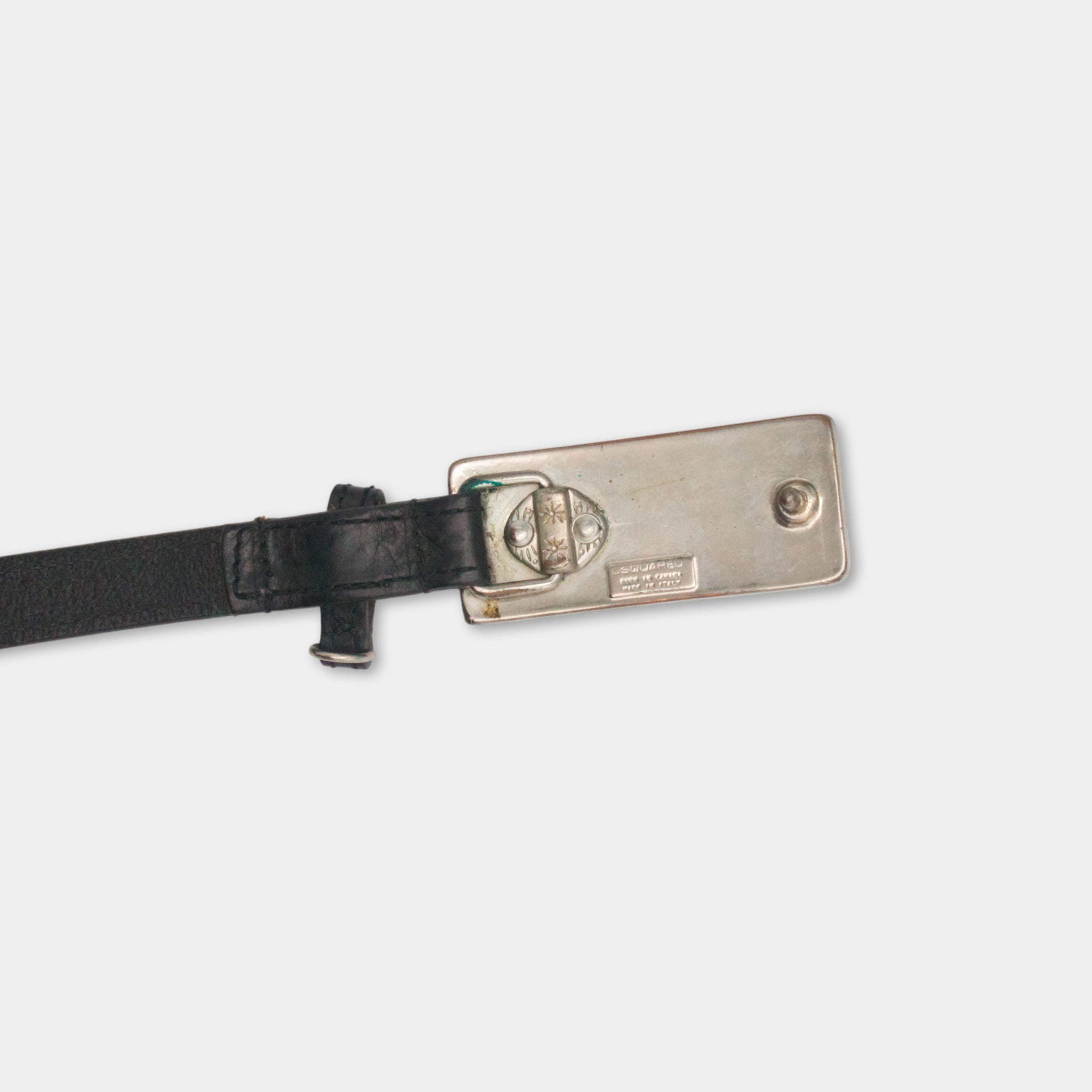 A black leather belt with a silver buckle is shown against a white background.
