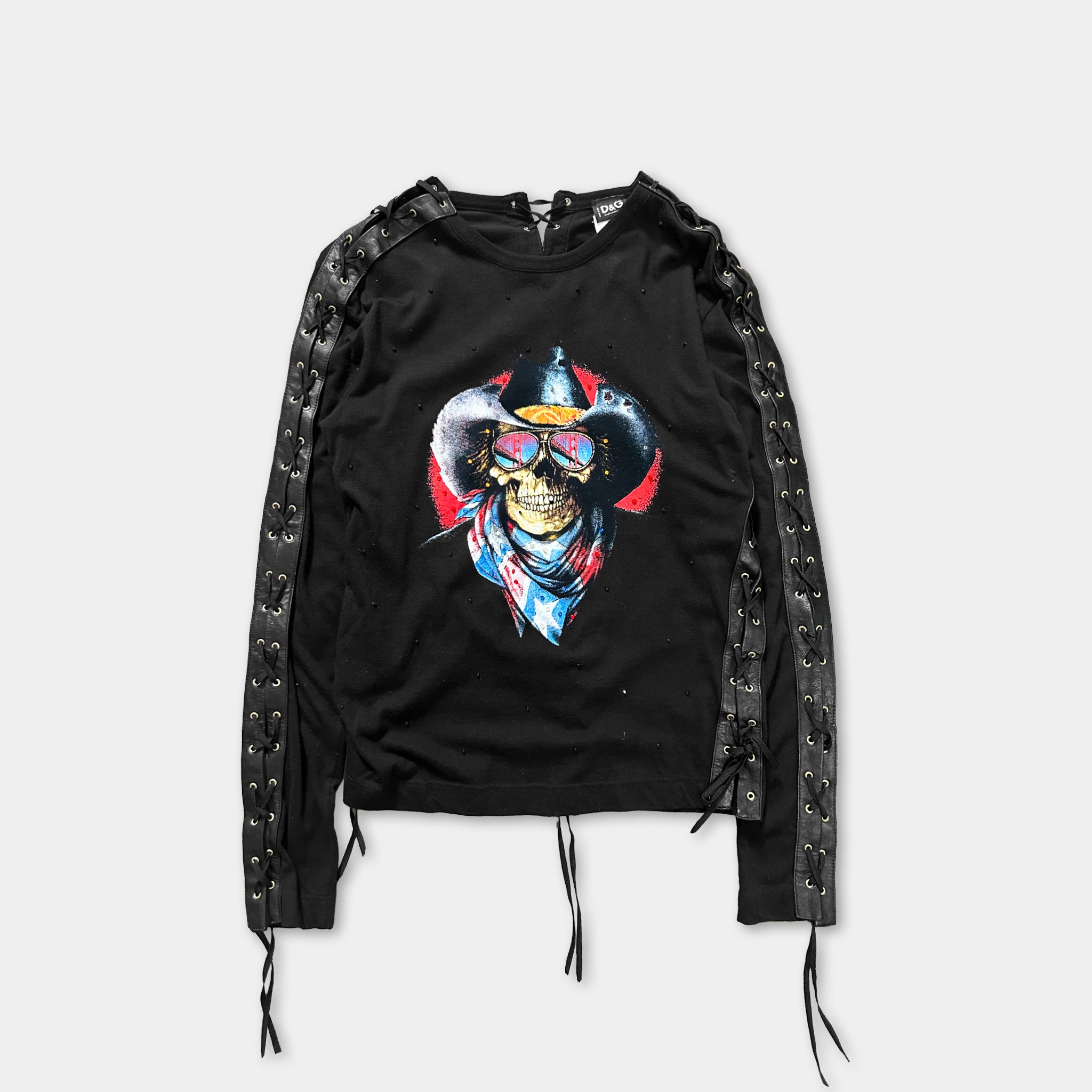 A black long-sleeved shirt with a graphic design of a skull wearing a cowboy hat and sunglasses.
