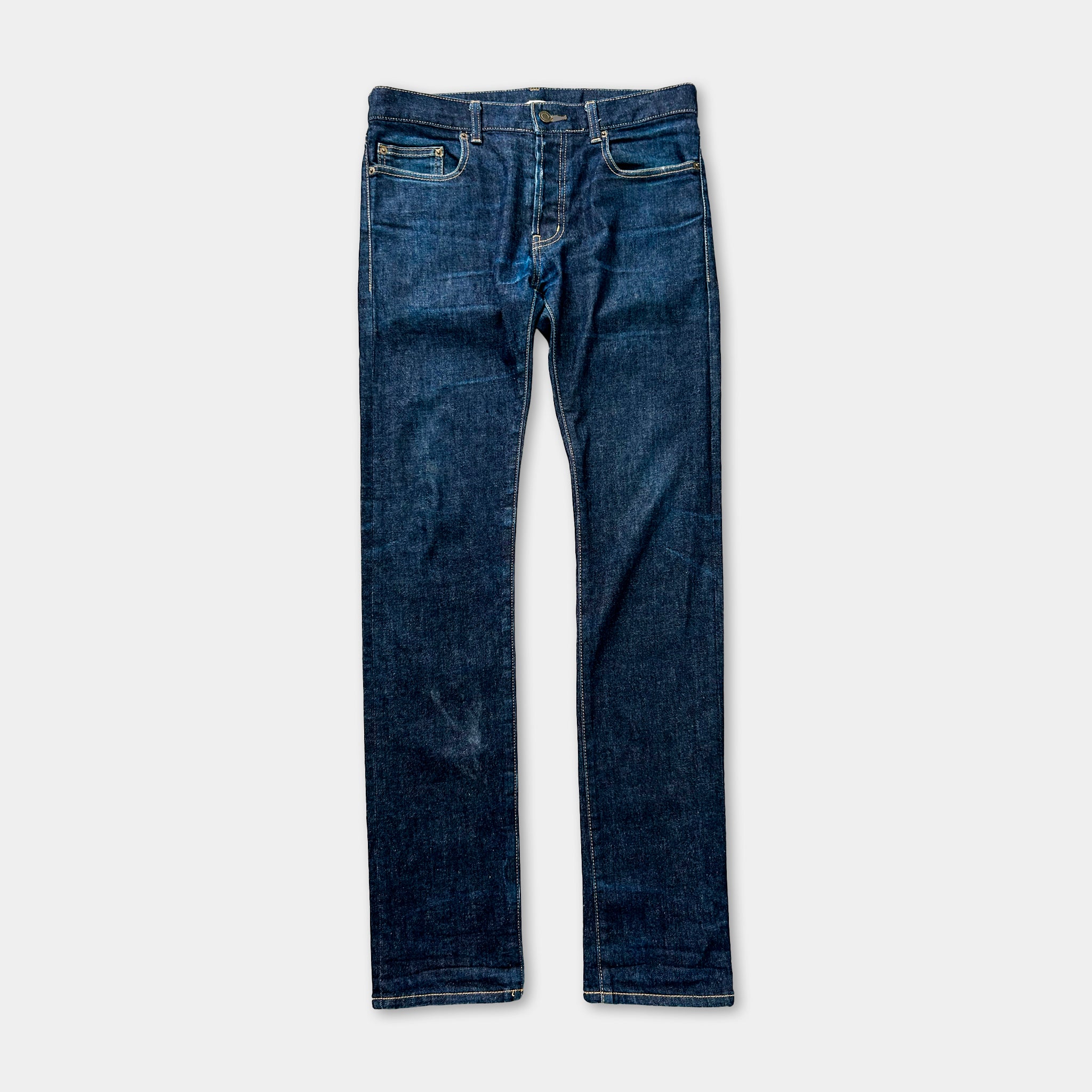 A pair of blue jeans with a classic design, featuring a pocket on the front and a zipper closure.