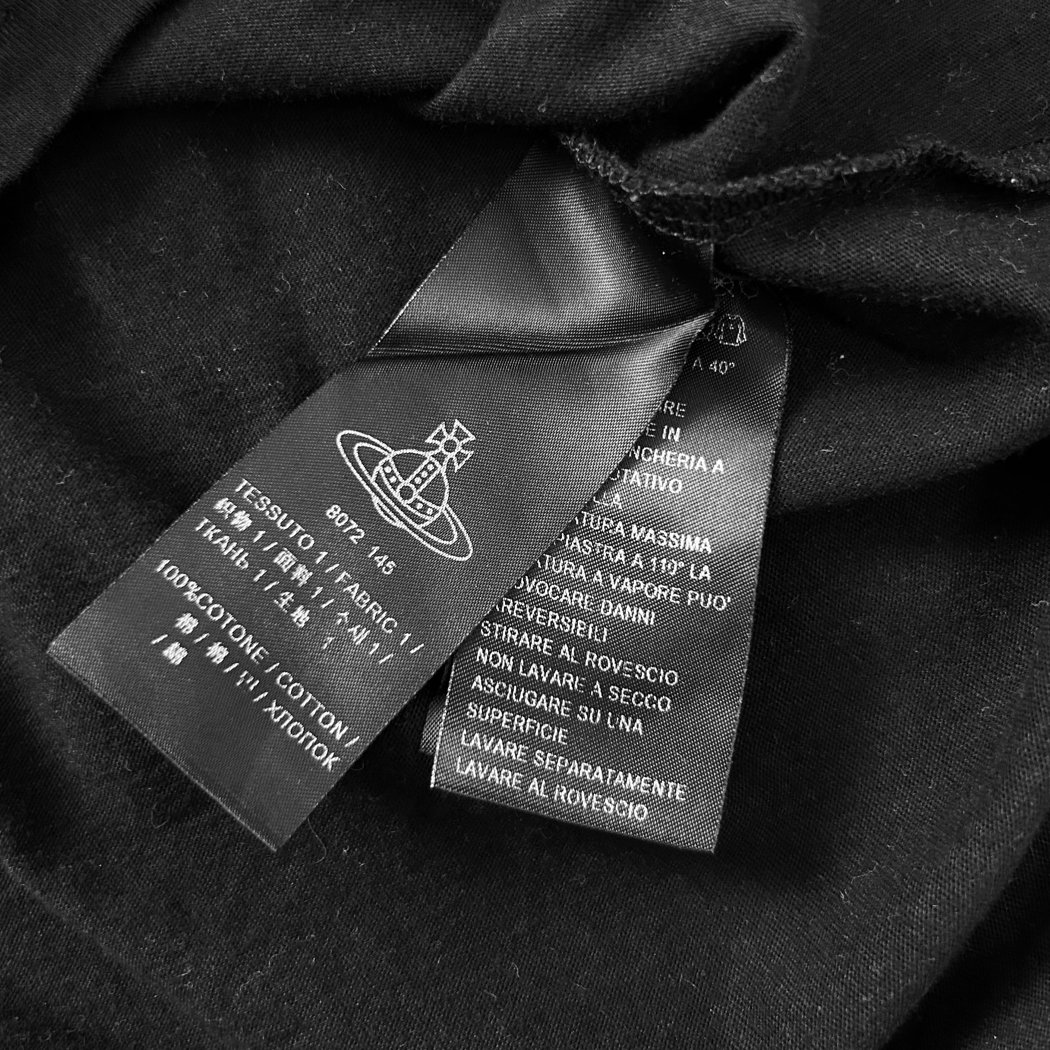 a close-up view of a black fabric with a label attached to it, which appears to be a piece of clothing.