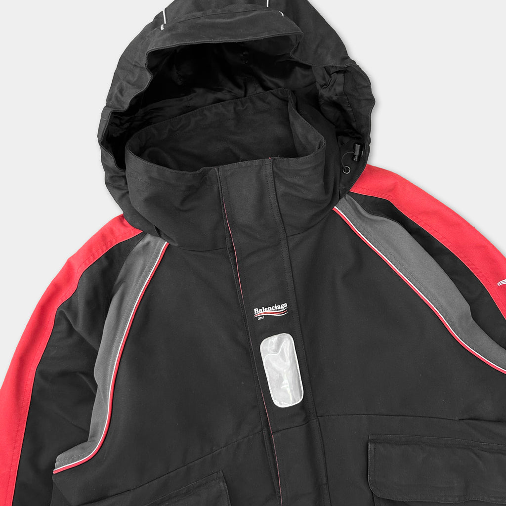 A black and red jacket with a red stripe on the sleeves and a red zipper running down the front.