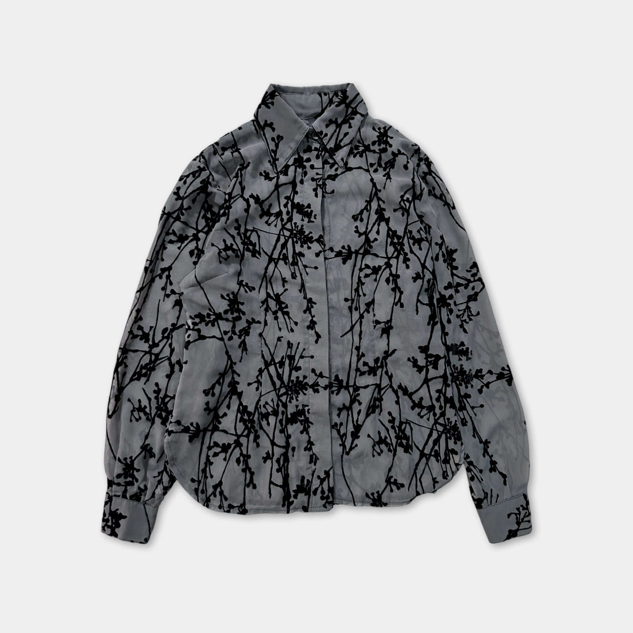 a gray shirt with a black leaf pattern.