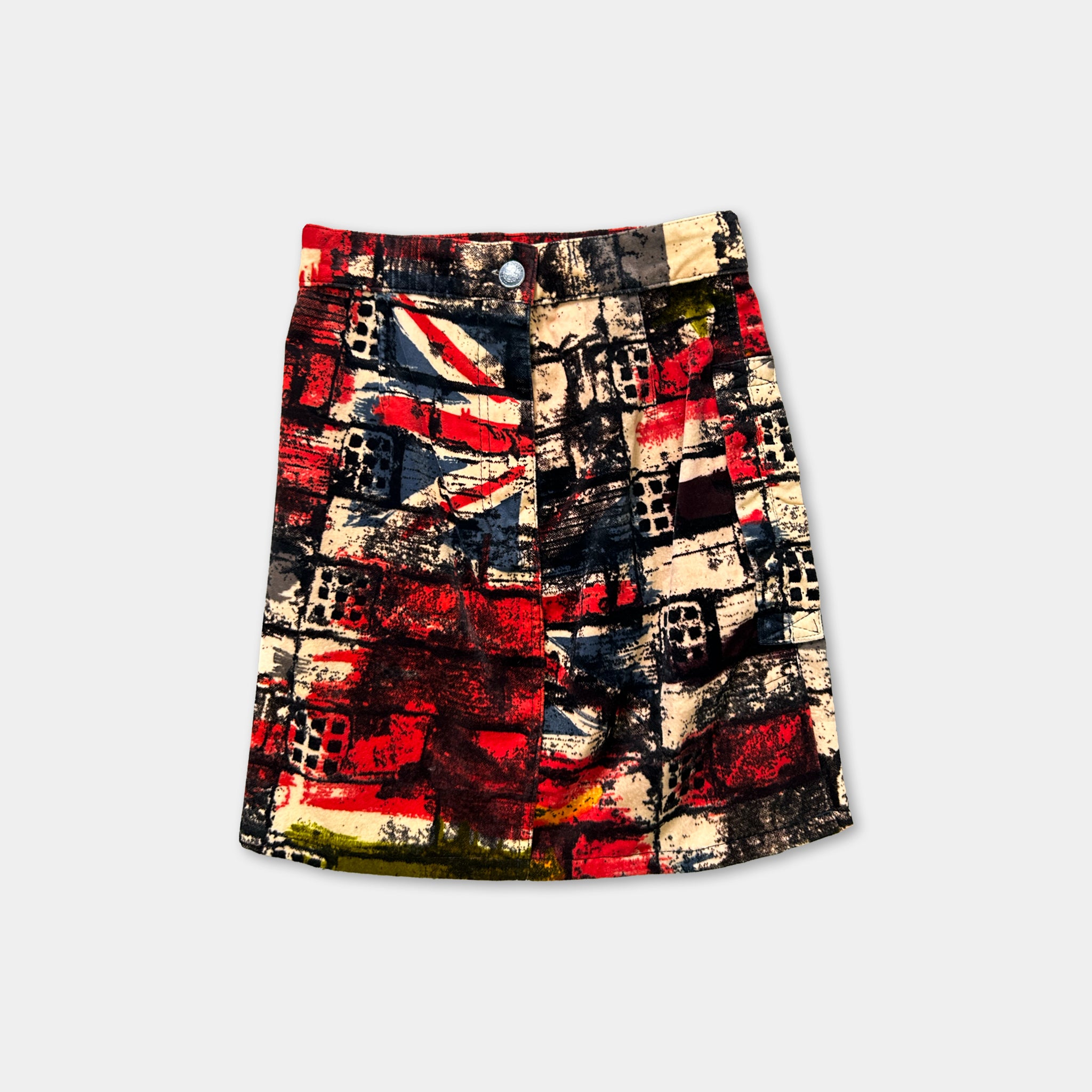 A colorful, patterned skirt with a bold, abstract design in red, black, and white.