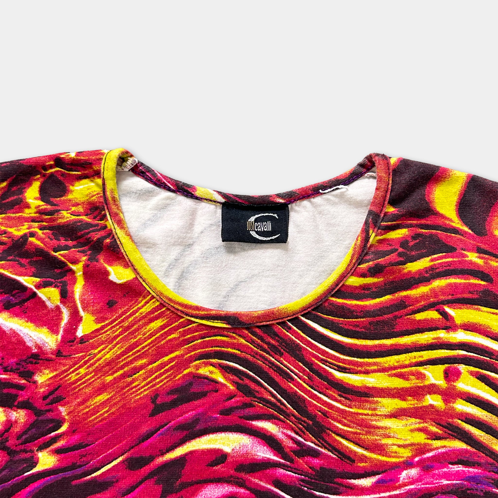 a colorful, patterned t-shirt with a vibrant design of red, yellow, and orange hues.