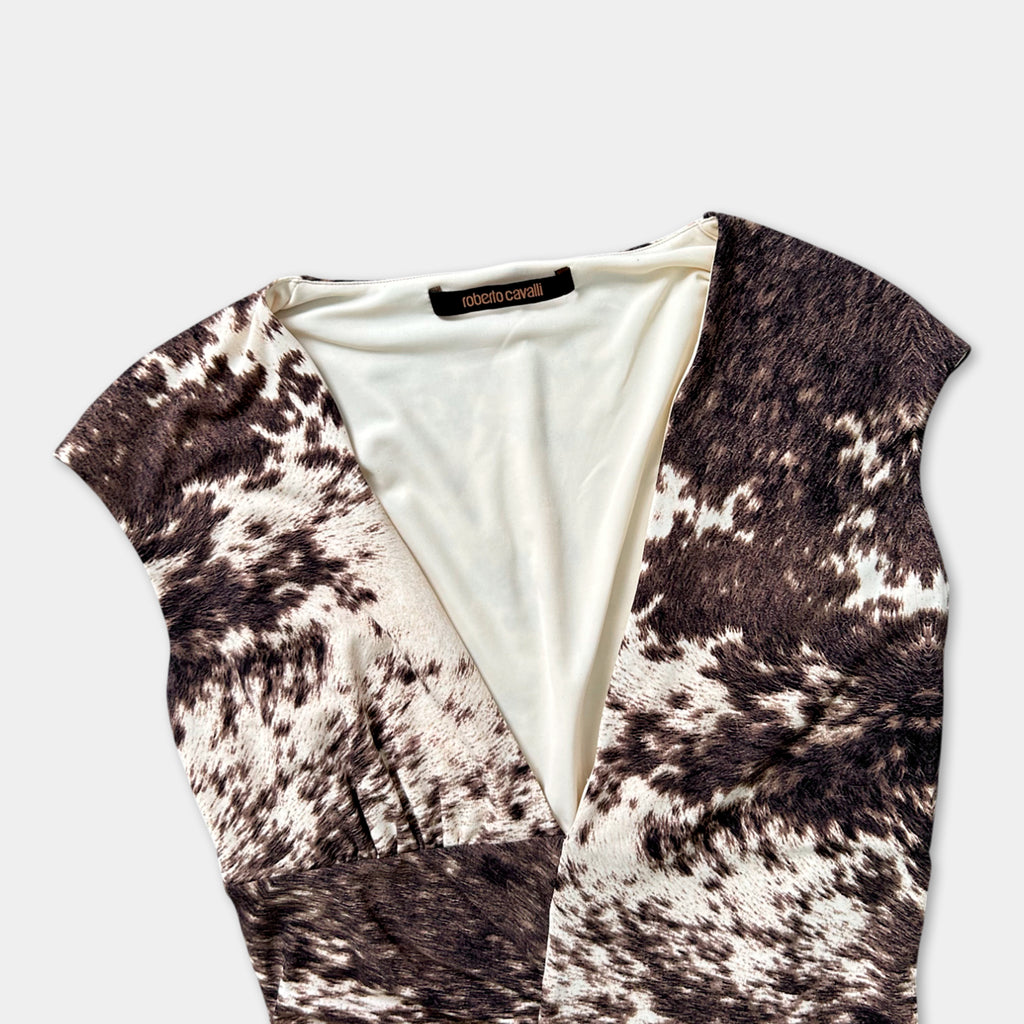 a close-up view of a v-neck dress with a pattern of brown and white spots.