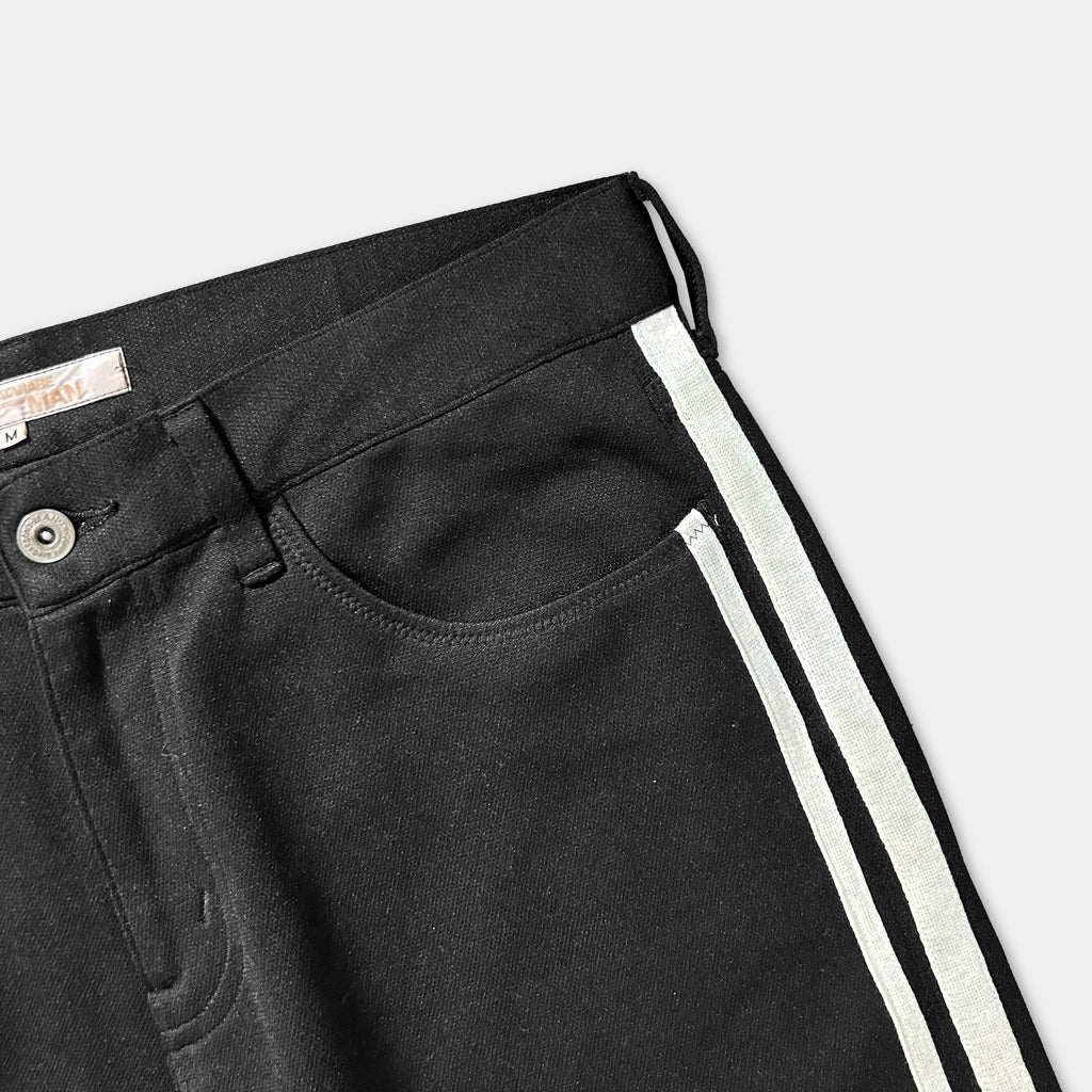 A pair of black pants with a white stripe down the side.