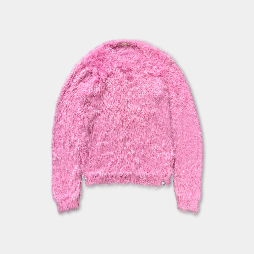 A pink fuzzy sweater is displayed against a white background.
