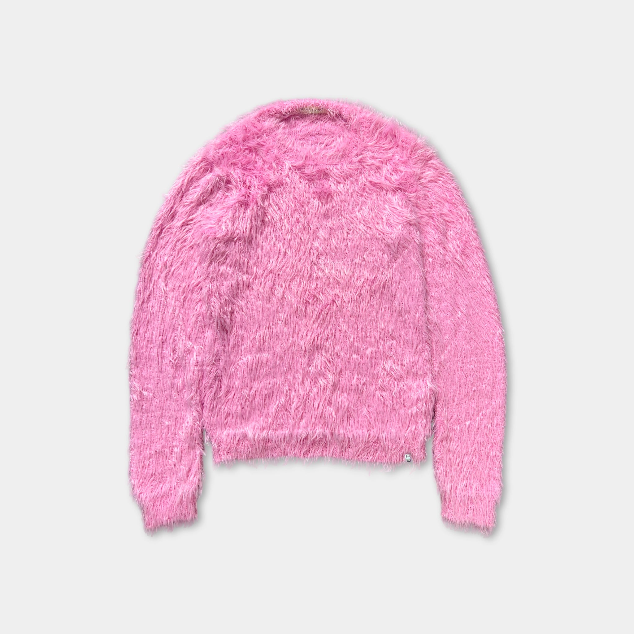 A pink fuzzy sweater is displayed against a white background.