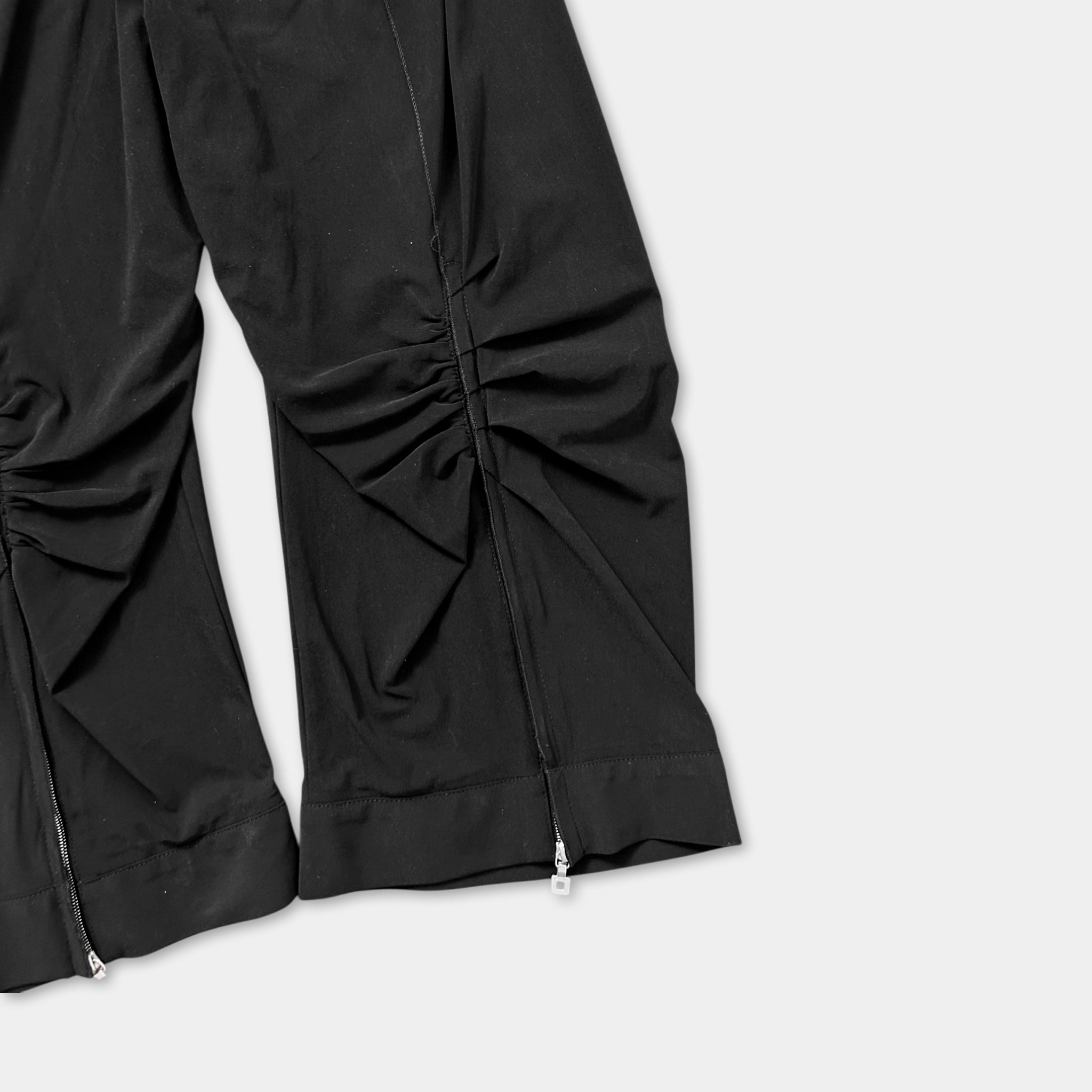 a pair of black pants with a zipper detail.
