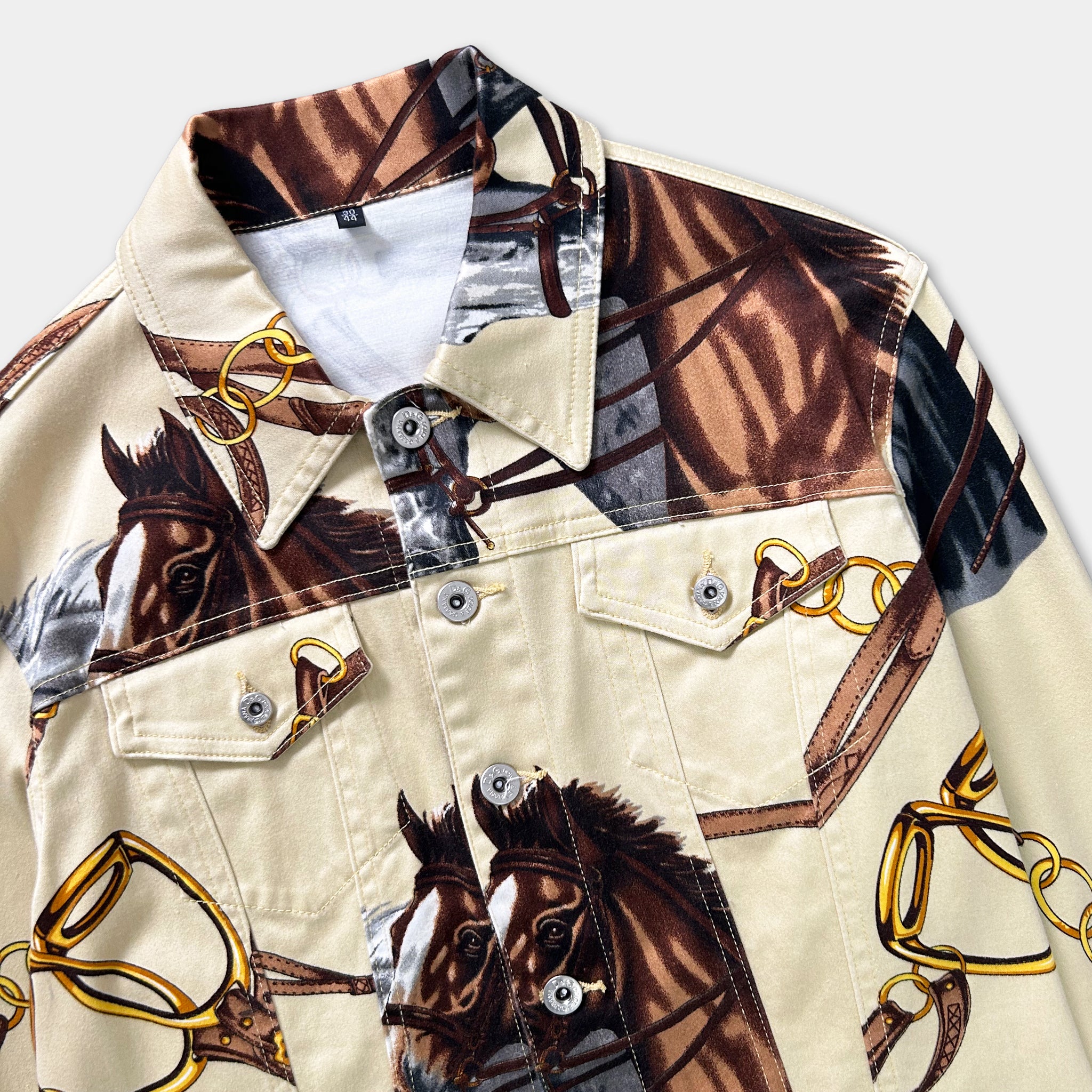 a close-up of a jacket with a unique printed design of horses and chains.