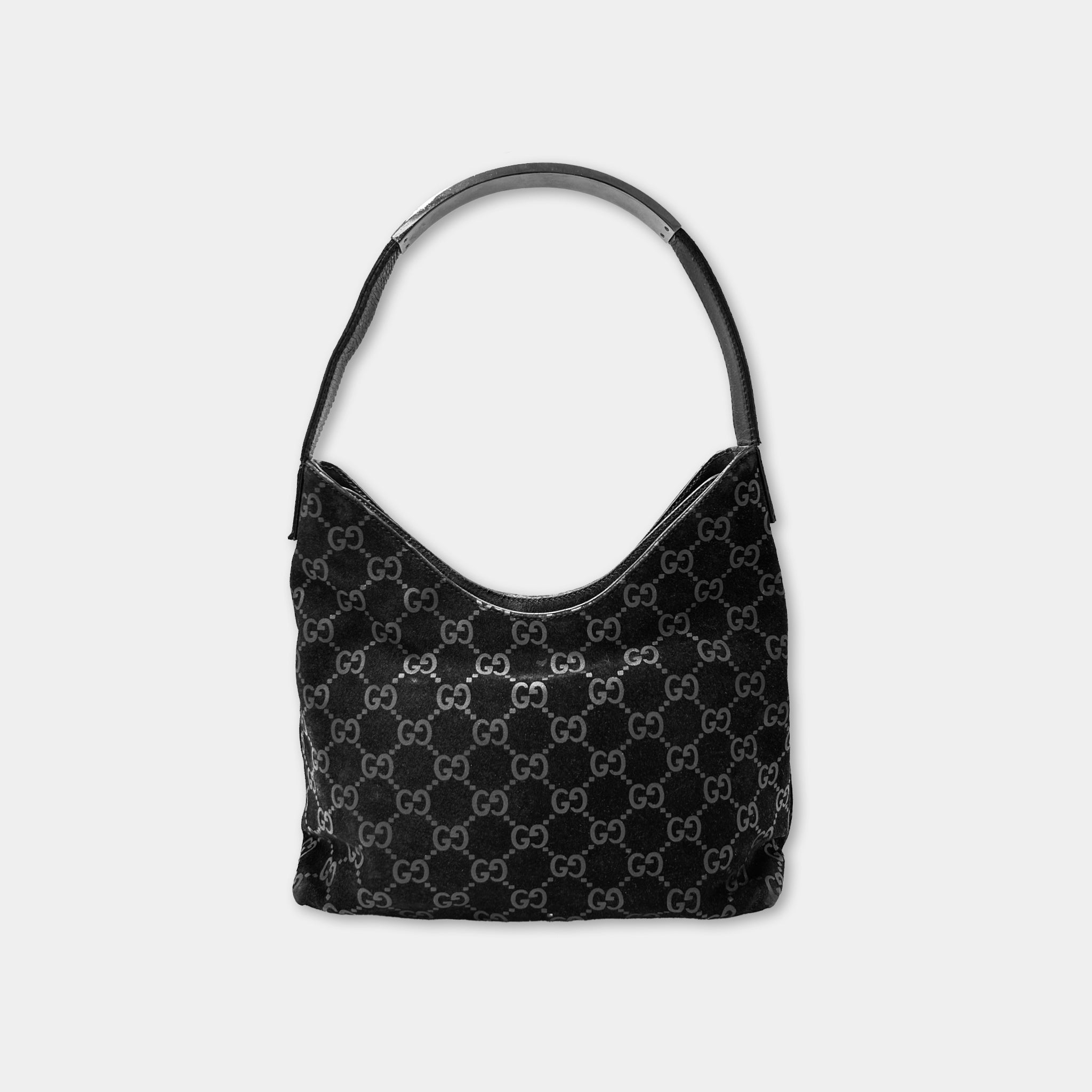 A black Gucci handbag with a distinctive monogram pattern.