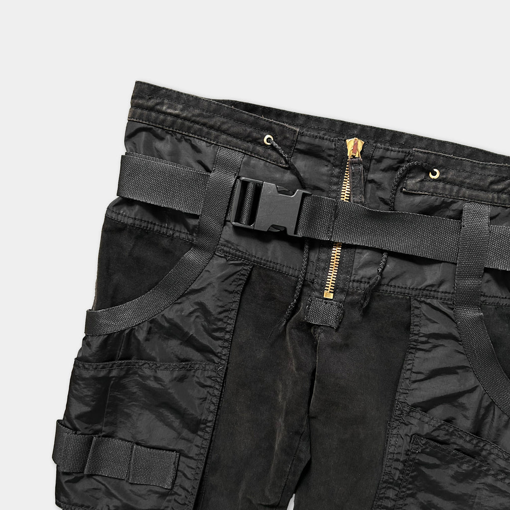 A pair of black cargo pants with multiple pockets and a zipper closure.