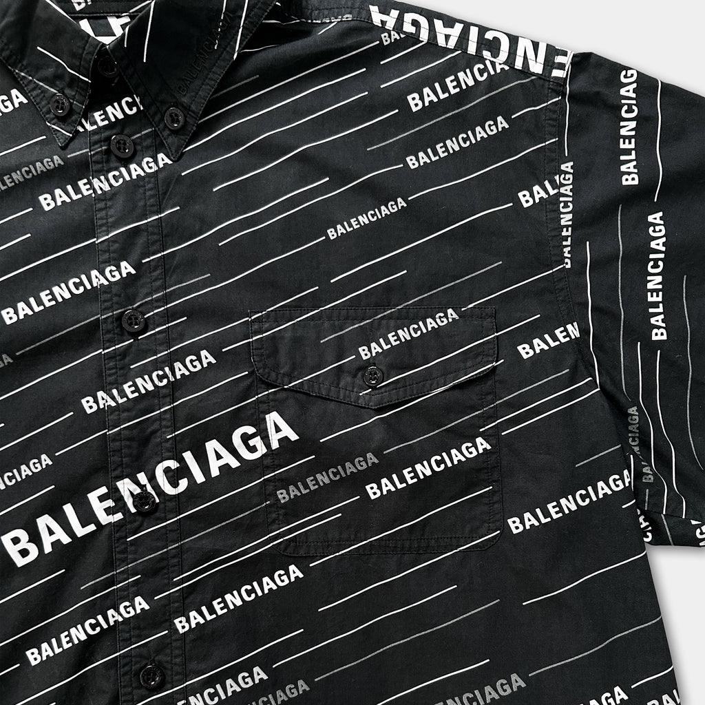 a close-up view of a black shirt with the word "BALENCIAGA" printed on it in white text.