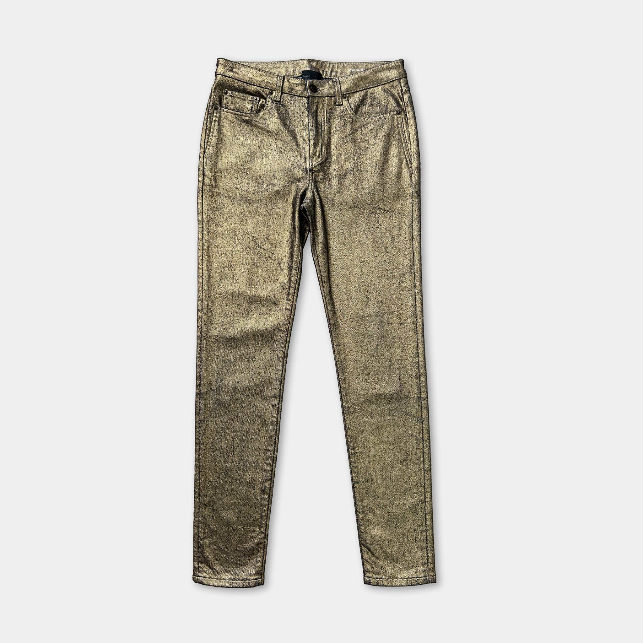 A pair of gold-colored, shiny, and textured skinny jeans.