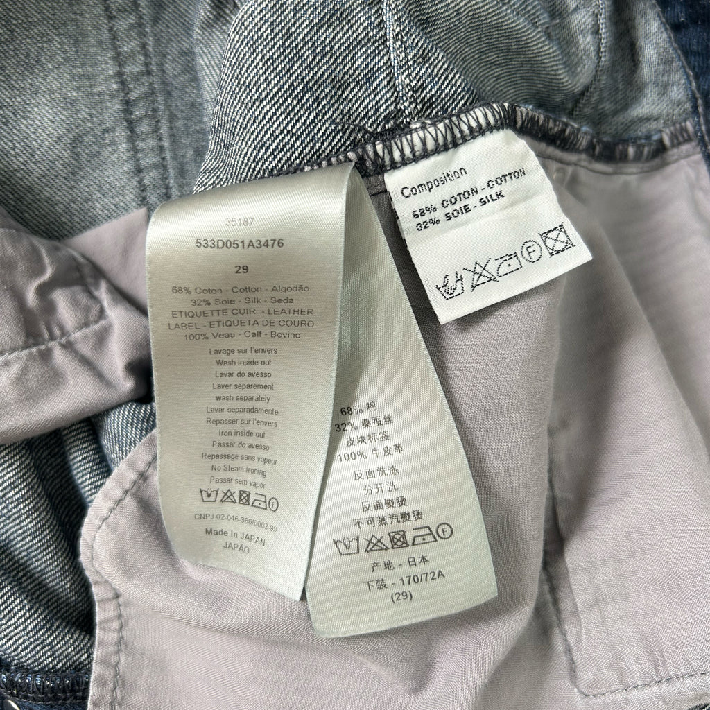 a pair of jeans with a label attached to the waistband, providing information about the jeans' material, care instructions, and washing details.