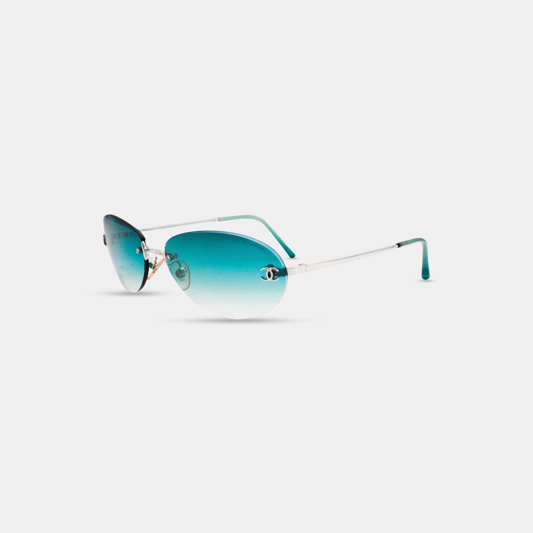 A pair of blue-tinted sunglasses with a silver frame, displayed against a white background.