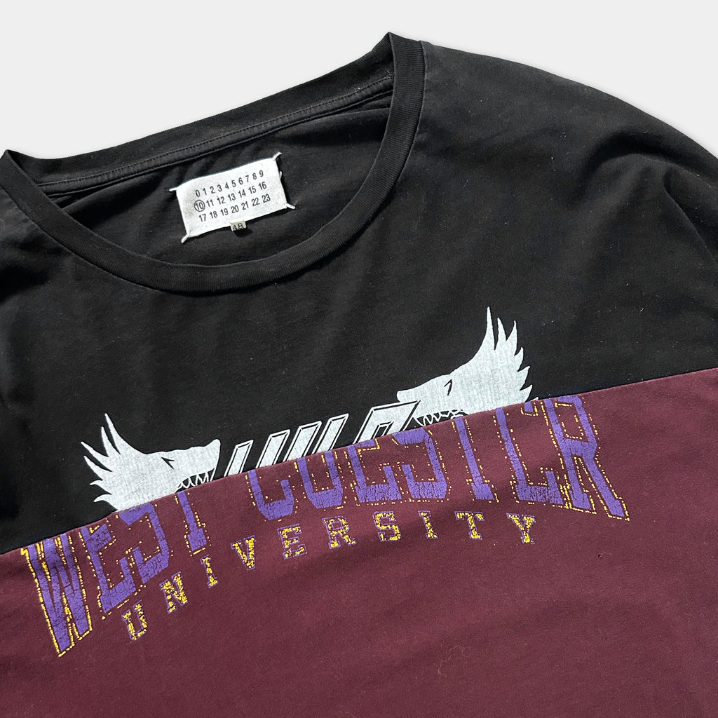 A black t-shirt with a white and purple graphic design, featuring the text "WEST UNIVERSITY" printed on it.