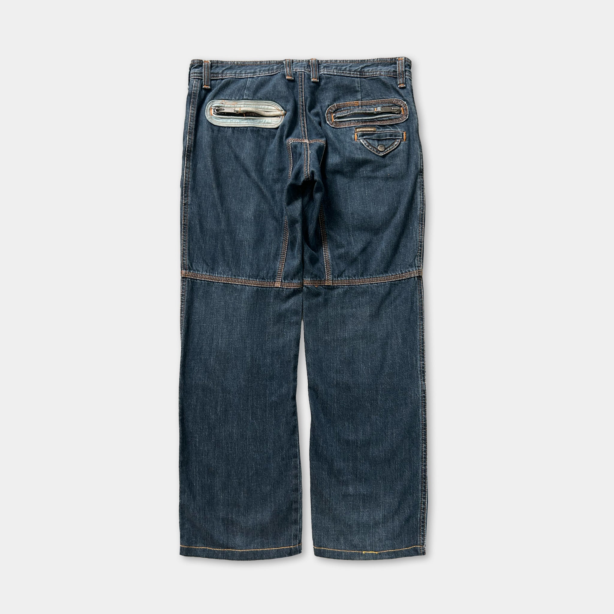 A pair of blue jeans with multiple pockets and zipper details.