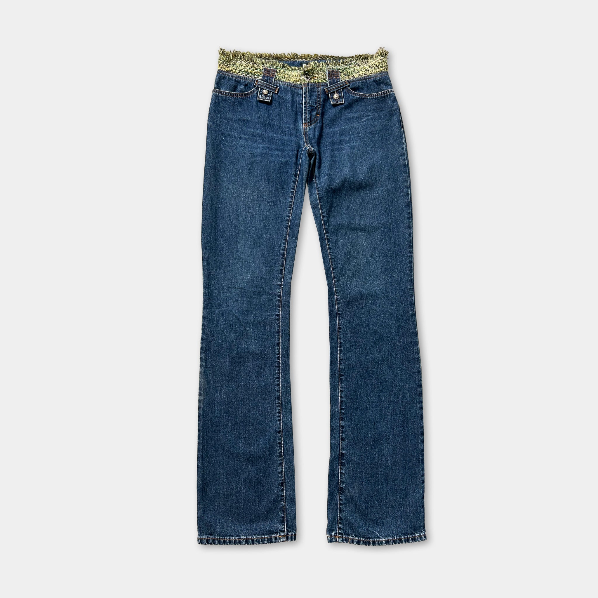 A pair of blue jeans with a yellow floral pattern on the waistband.