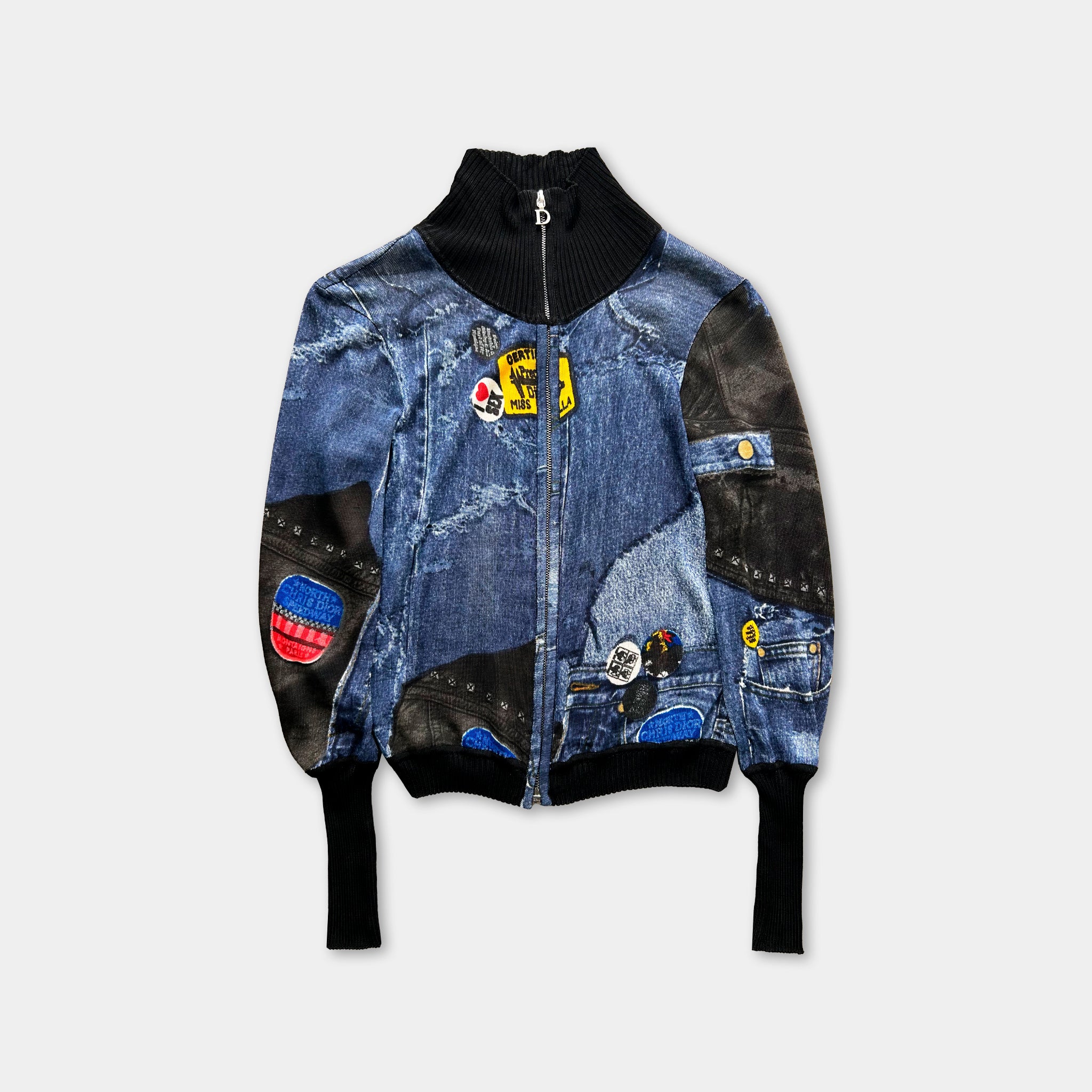 A denim jacket with a black collar and zipper, featuring various patches and designs on the fabric.
