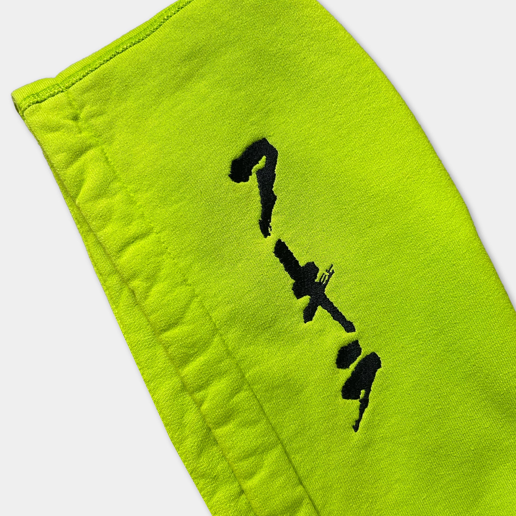 A bright yellow fabric with black text or symbols printed on it.