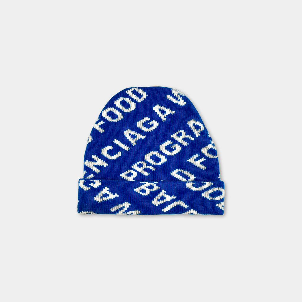 A blue knit beanie with white text on it.