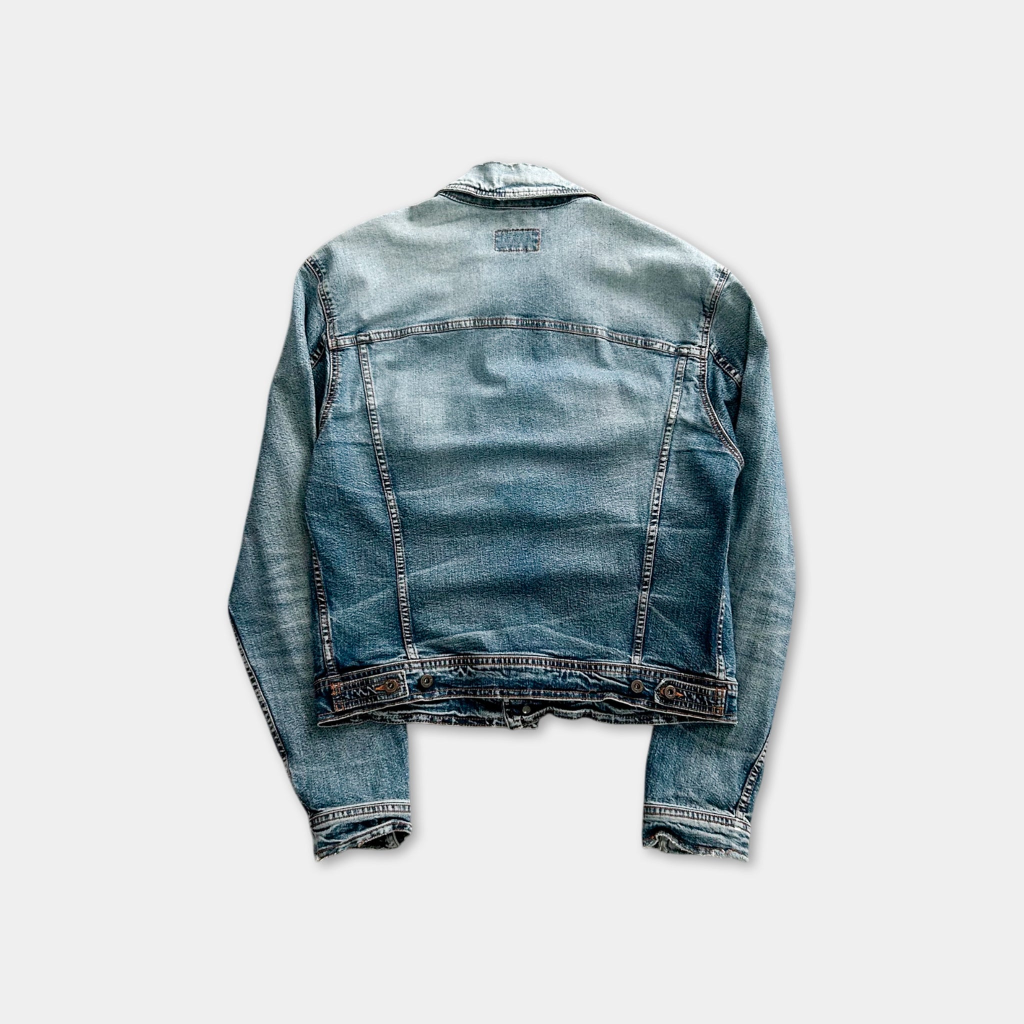 A denim jacket with a faded blue color and a zipper closure.