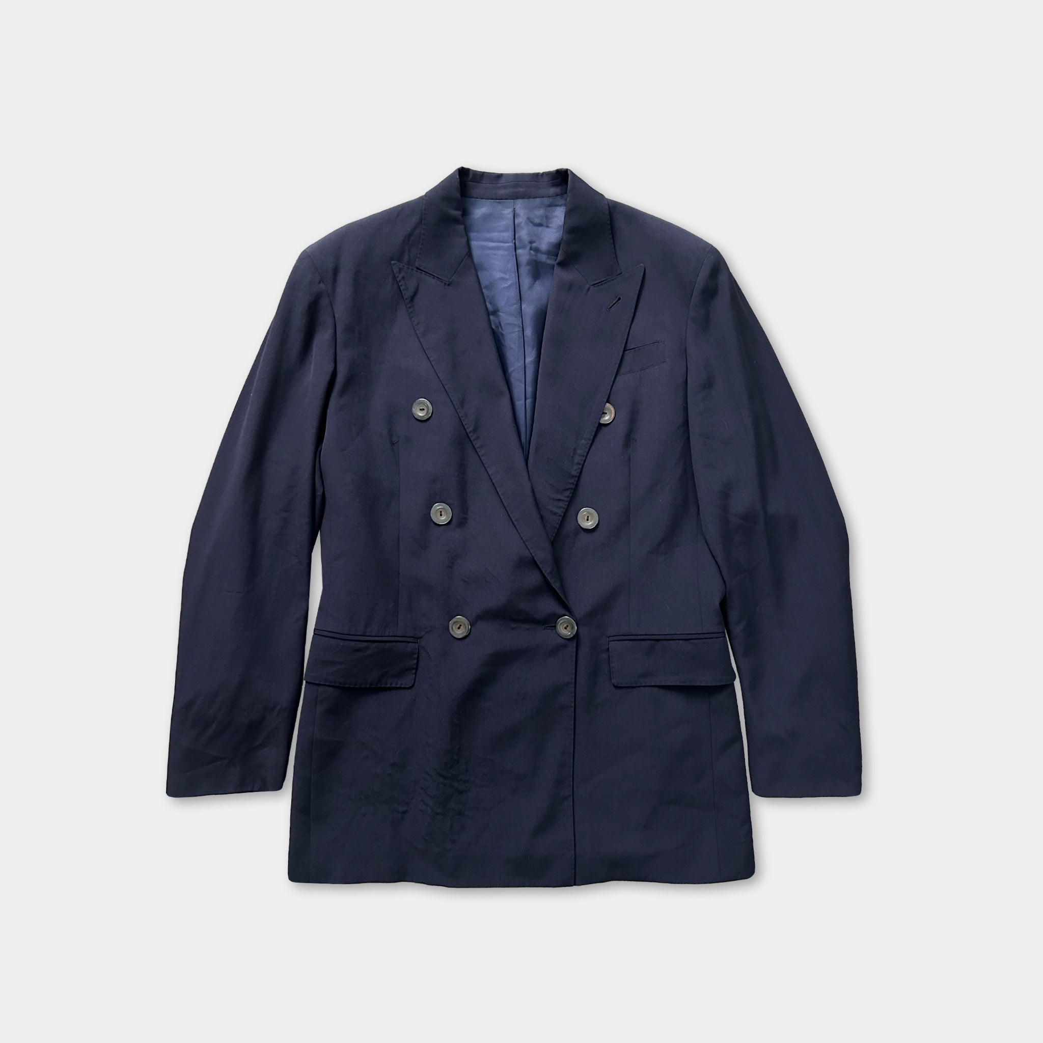 A navy blue double-breasted blazer with buttons and a front pocket, displayed against a white background.