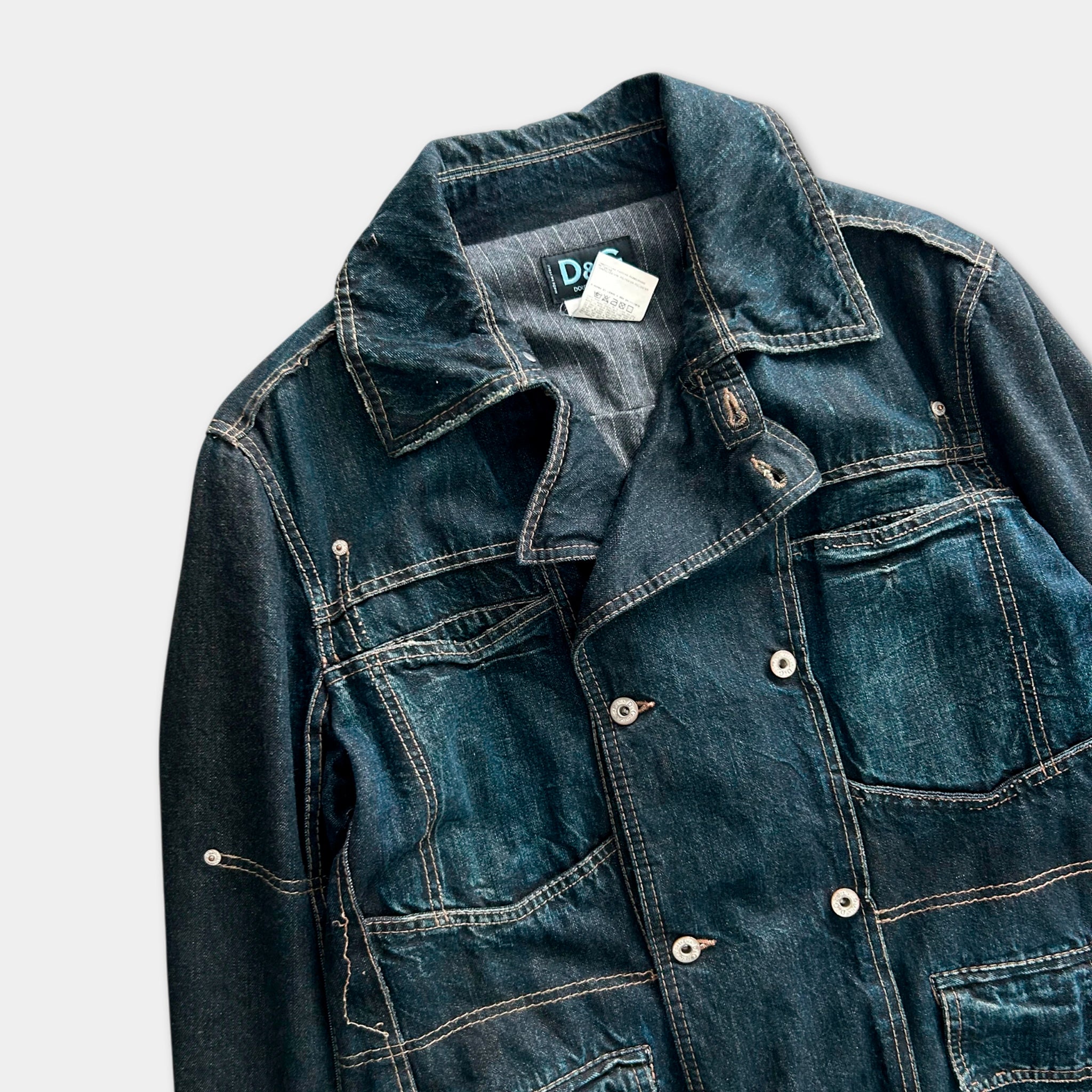 A denim jacket with a collar, pockets, and buttons, displayed against a plain background.
