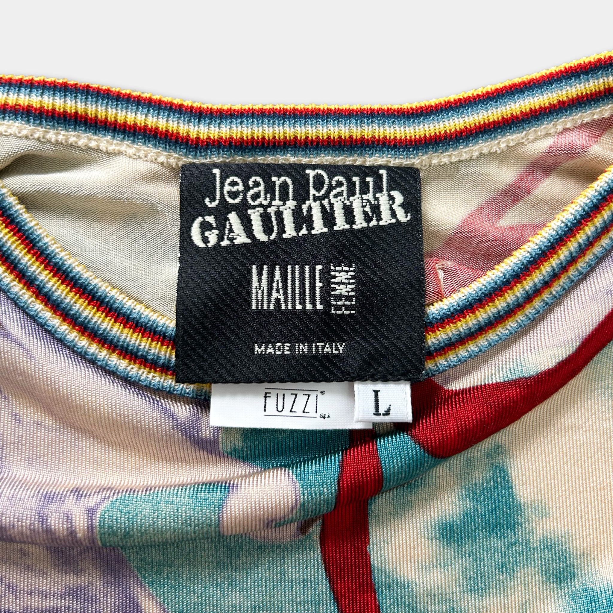 a close-up view of a colorful, patterned fabric with a label attached to it, indicating the brand and product information.