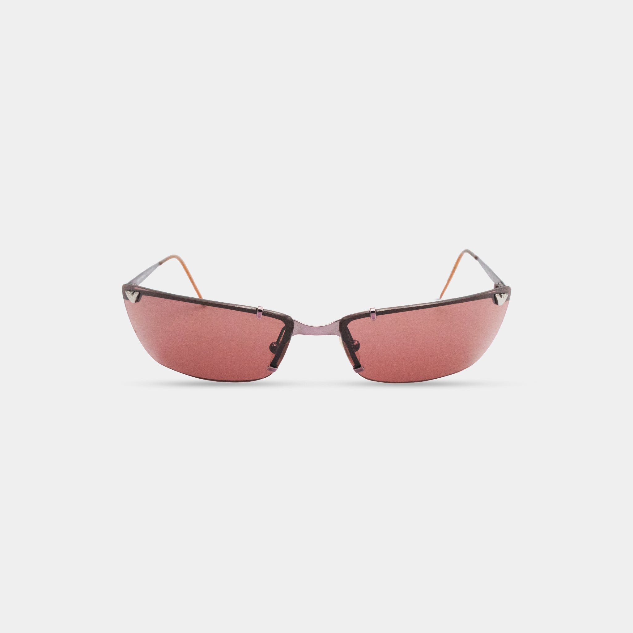 A pair of red-tinted sunglasses with a sleek, modern design.