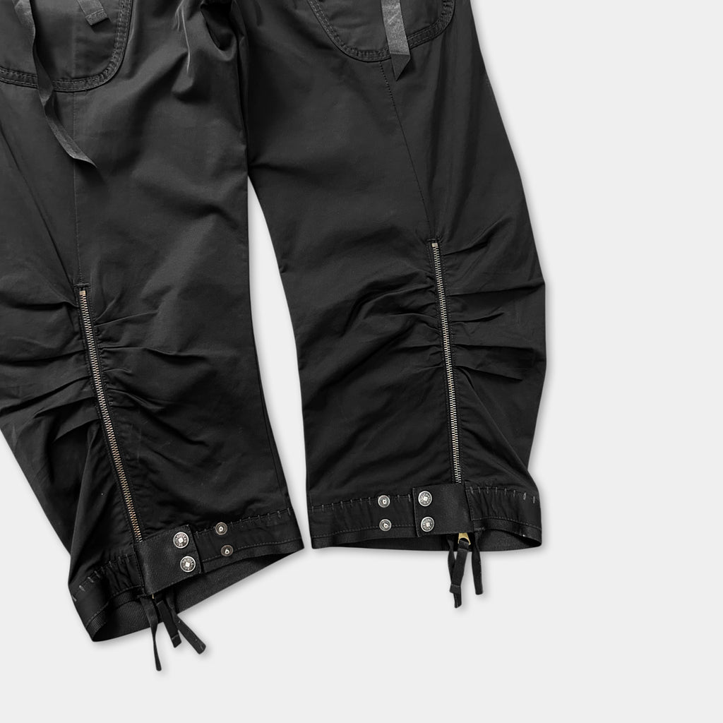 a pair of black pants with zippers and a ruched design.