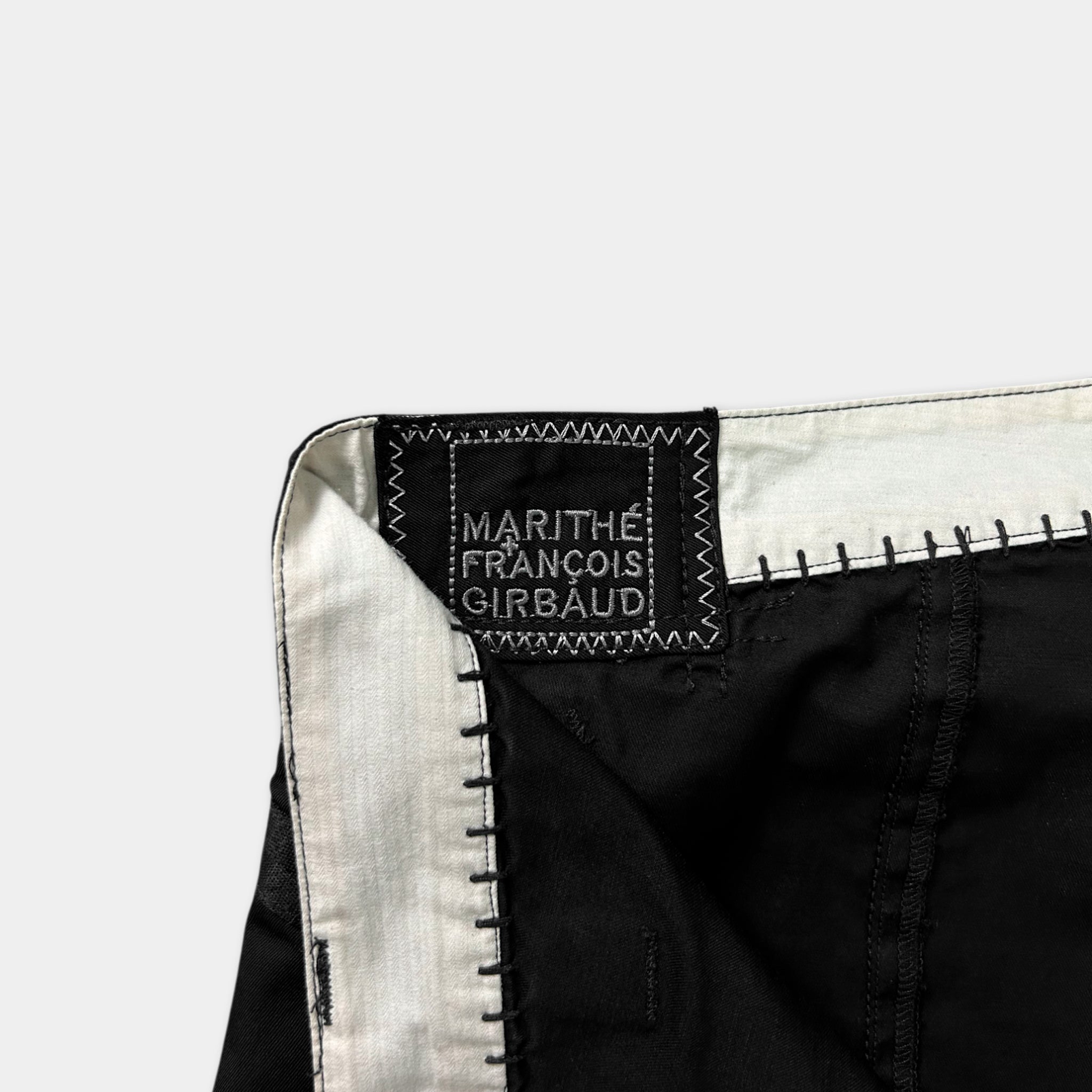 a close-up view of a black and white fabric, possibly a piece of clothing, with a label or tag attached to it.