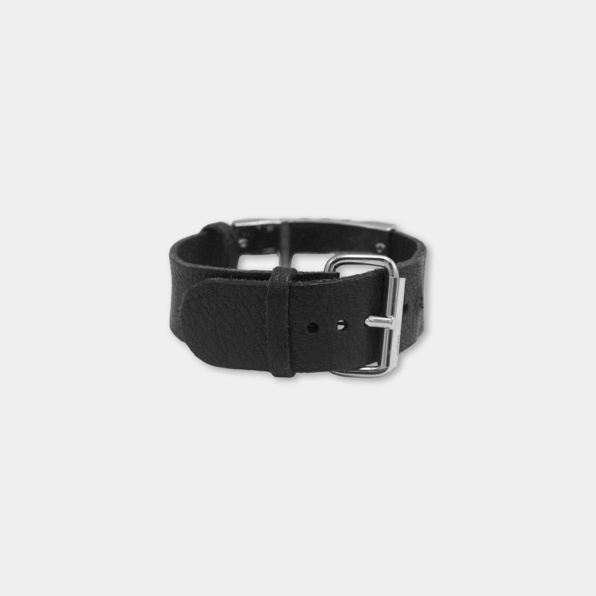 A black leather watch band with a metal buckle.